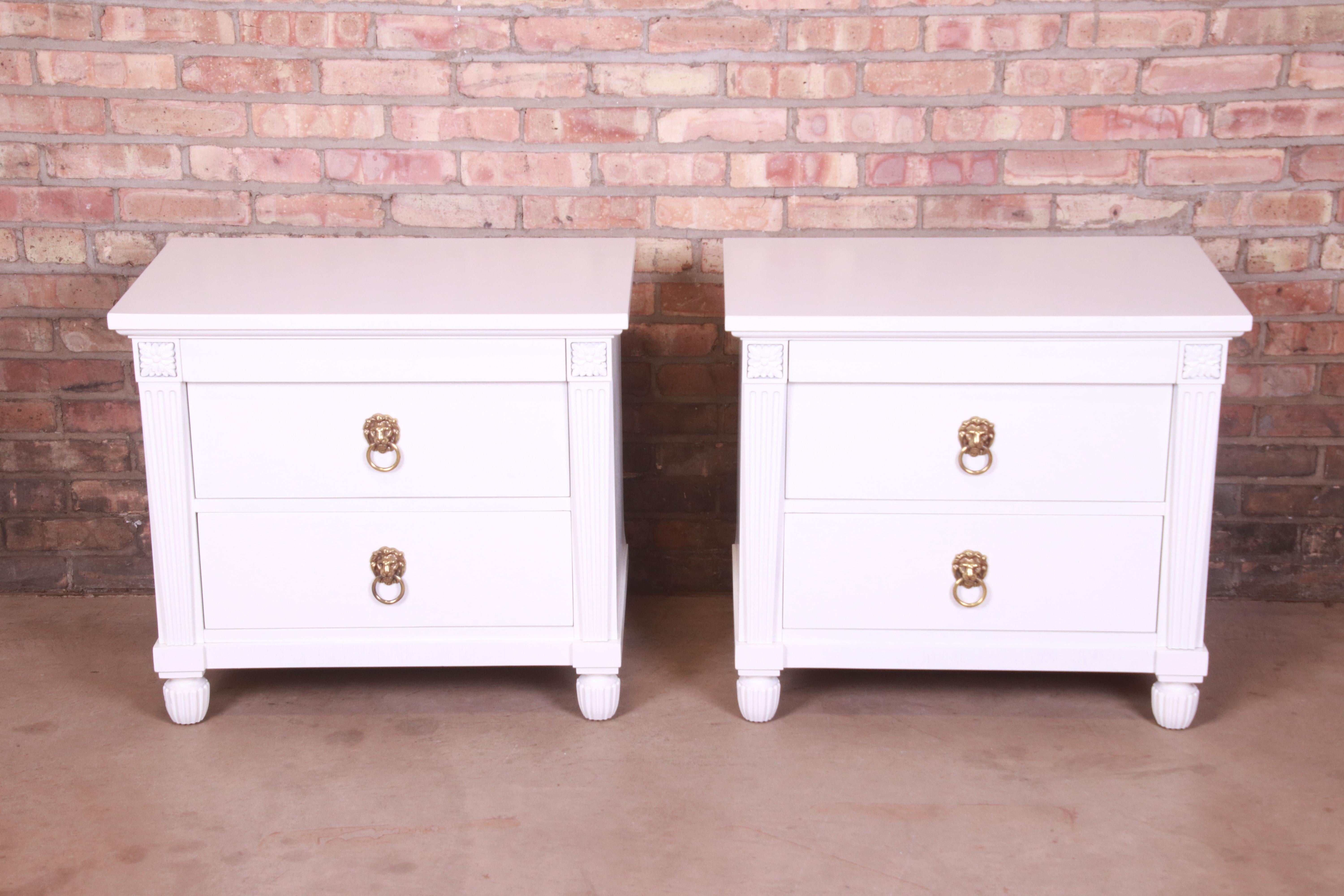 A gorgeous pair of Neoclassical or Empire style nightstands or end tables

By Baker Furniture

USA, Circa 1980s

White lacquered carved mahogany, with original lion head brass hardware.

Measures: 28