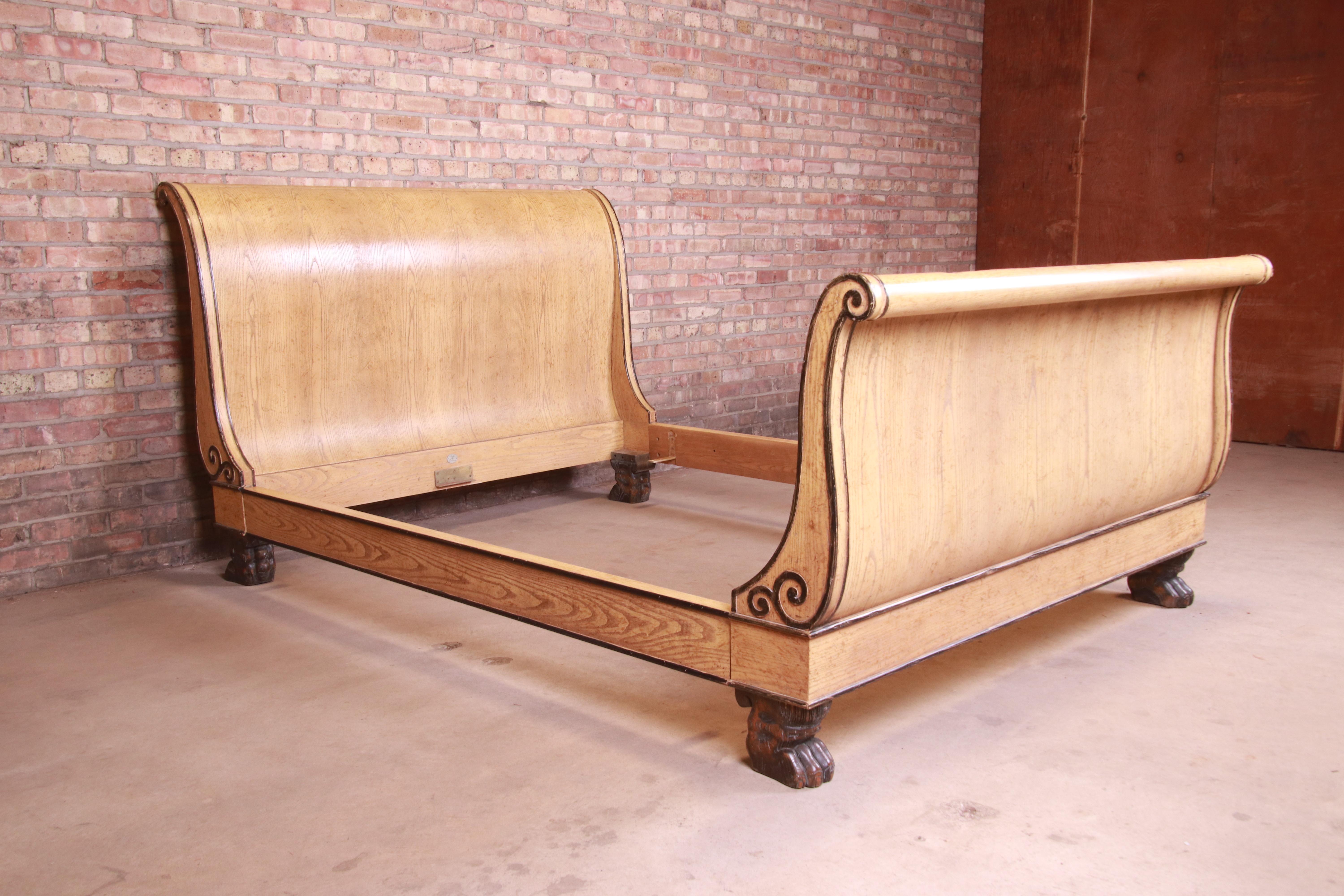 A gorgeous neoclassical or Empire style queen size sleigh bed

By Baker Furniture

USA, circa 1960s

White oak, with ebonized paw feet and scrollwork.

Measures: 65