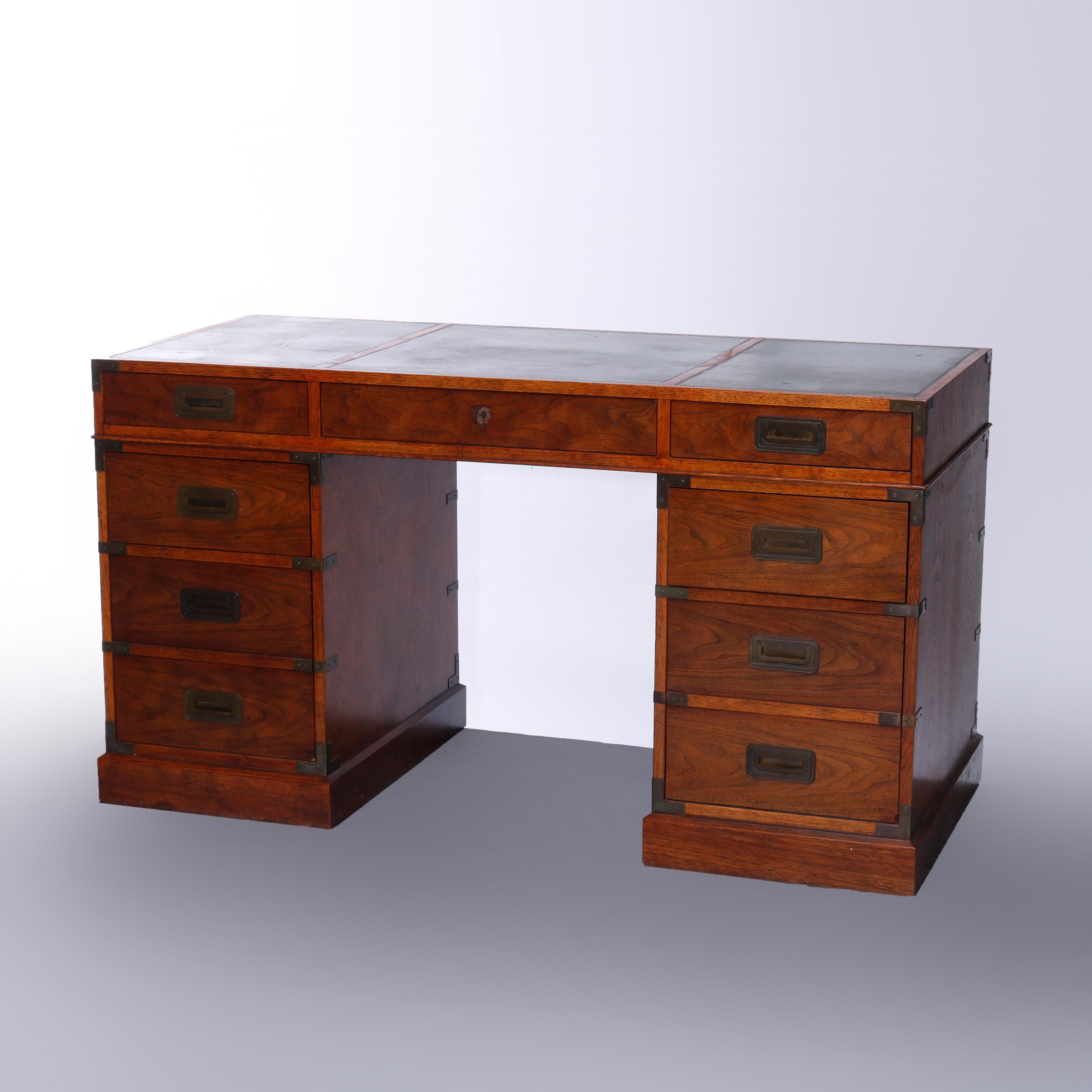 A writing desk by Baker Furniture Milling Road, offers oak construction with segmented writing surface over central single drawer flanked by drawer towers, maker mark branded on drawer interior as photographed, 20th century

Measures - 30''H x
