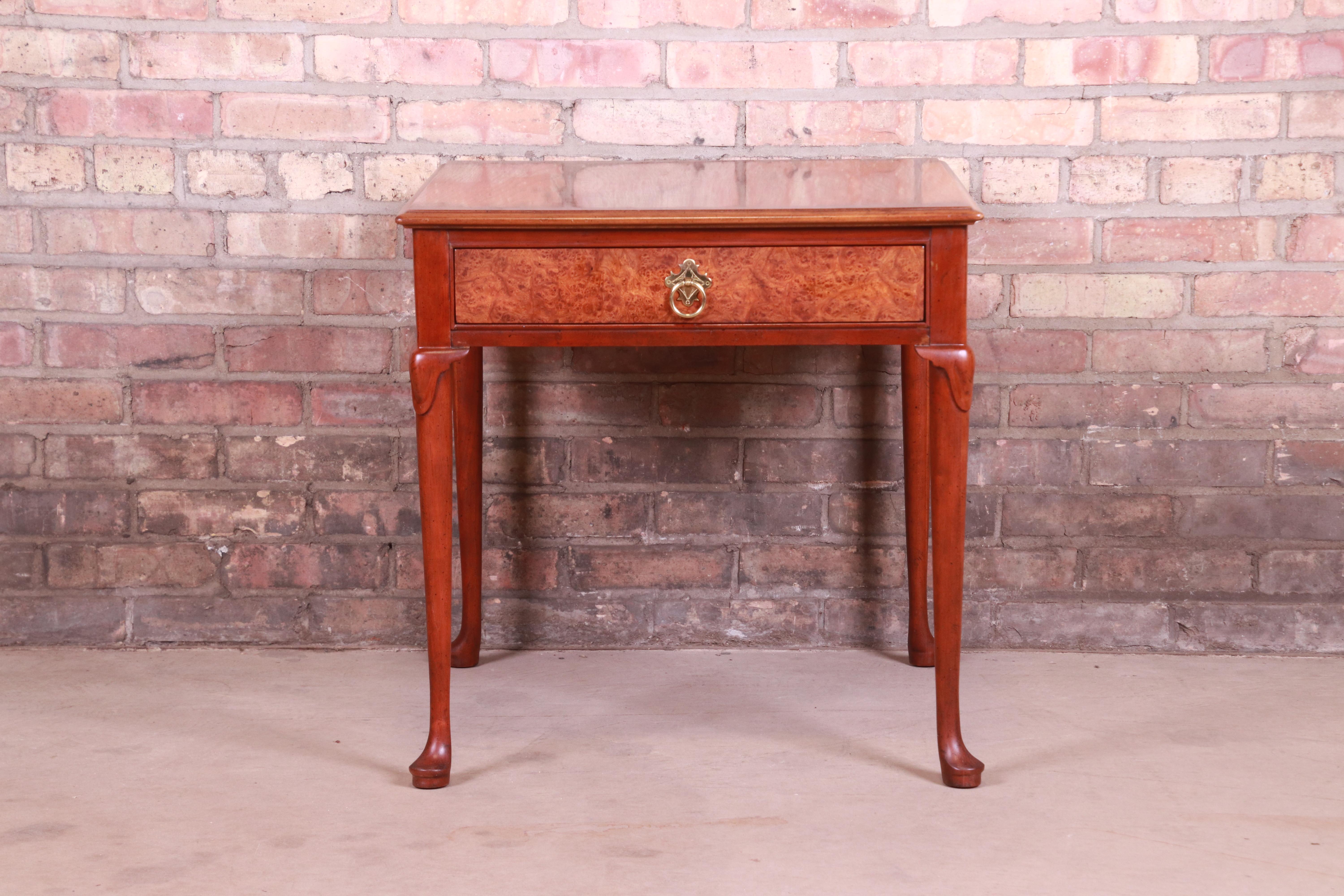 A gorgeous Queen Anne style occasional side table or nightstand

By Baker Furniture

USA, Late 20th Century

Walnut, with burl wood drawer front and original brass hardware.

Measures: 24