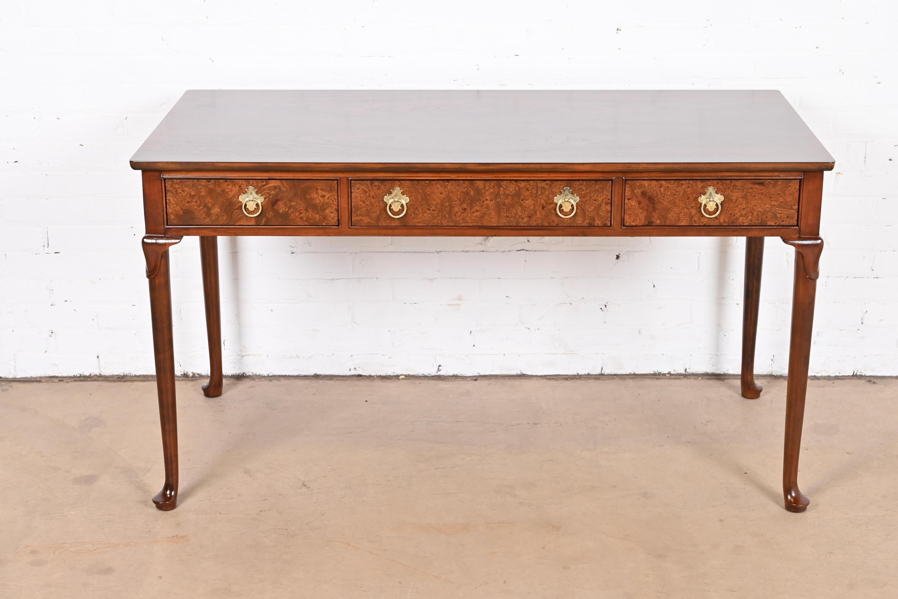 A gorgeous Queen Anne or Chippendale style writing desk

By Baker Furniture

USA, circa 1980s

Book-matched walnut, with gorgeous burl wood drawer fronts and brass hardware.

Measures: 54