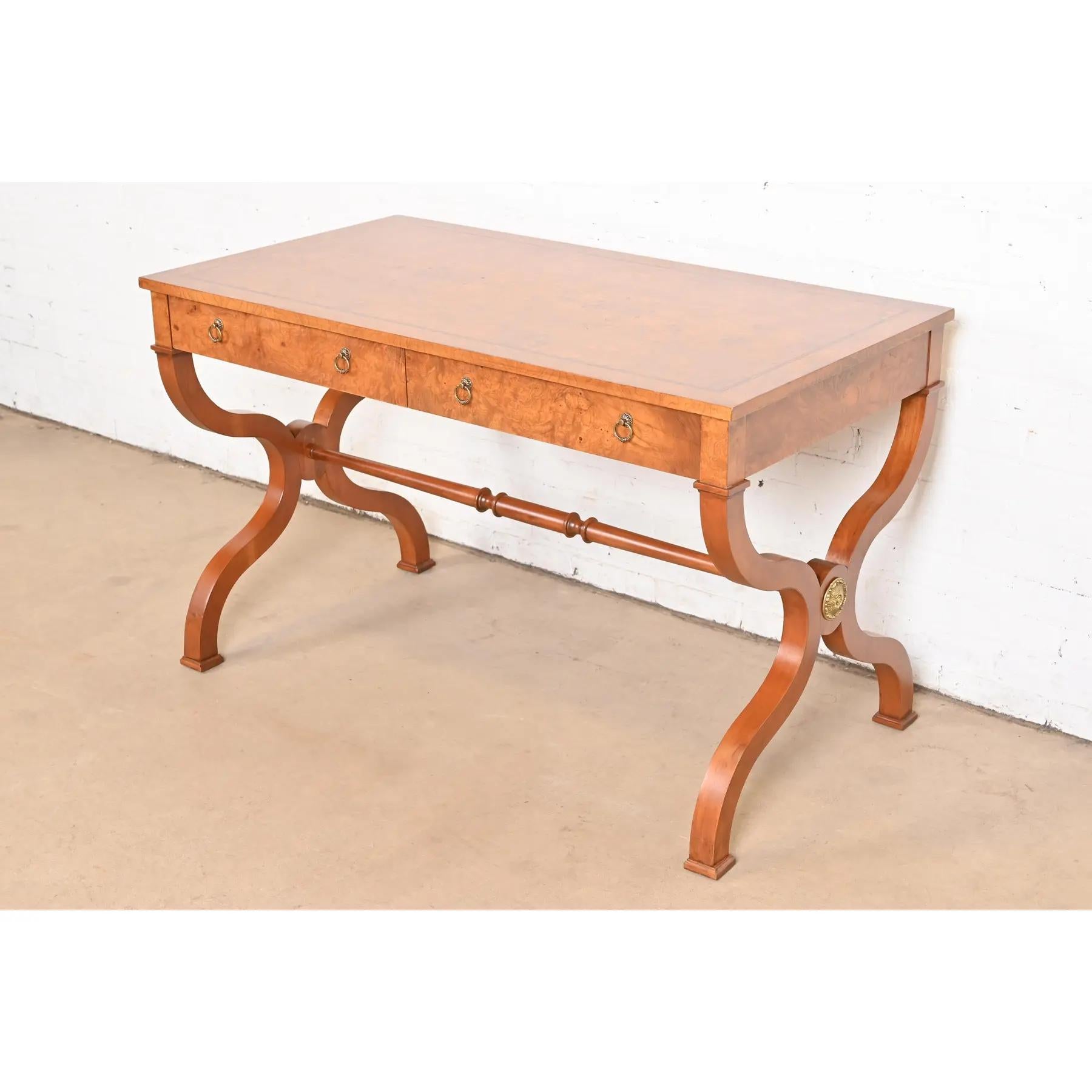 An exceptional Regency or Neoclassical style writing desk or library table

By Baker Furniture

USA, Circa 1980s

Gorgeous burled walnut, with original brass hardware.

Measures: 48