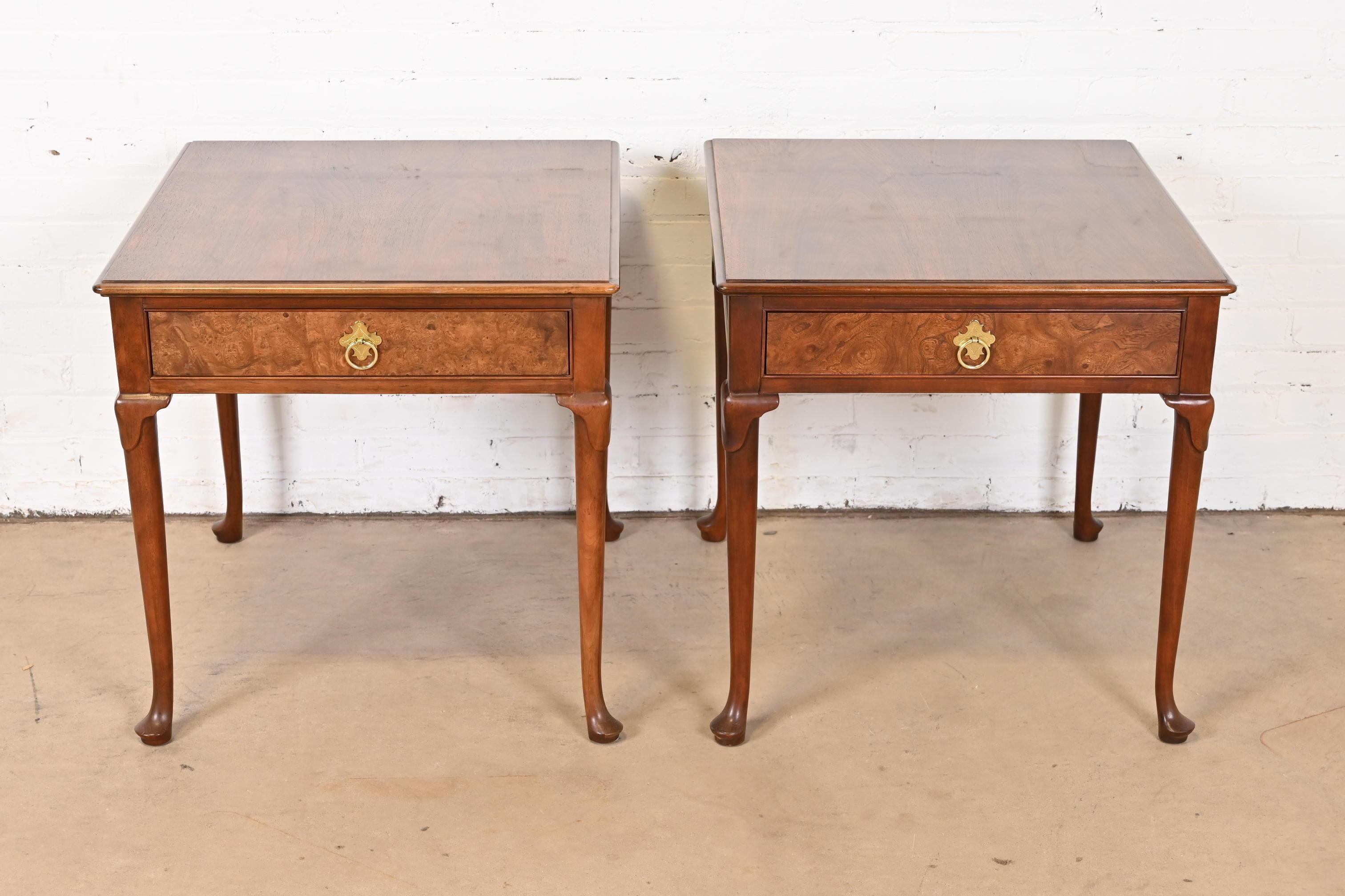 A gorgeous pair of Regency or Queen Anne style single drawer nightstands, tea tables, or occasional side tables

By Baker Furniture

USA, Circa 1980s

Book-matched walnut, with carved solid walnut legs, burl wood drawer fronts, and original brass