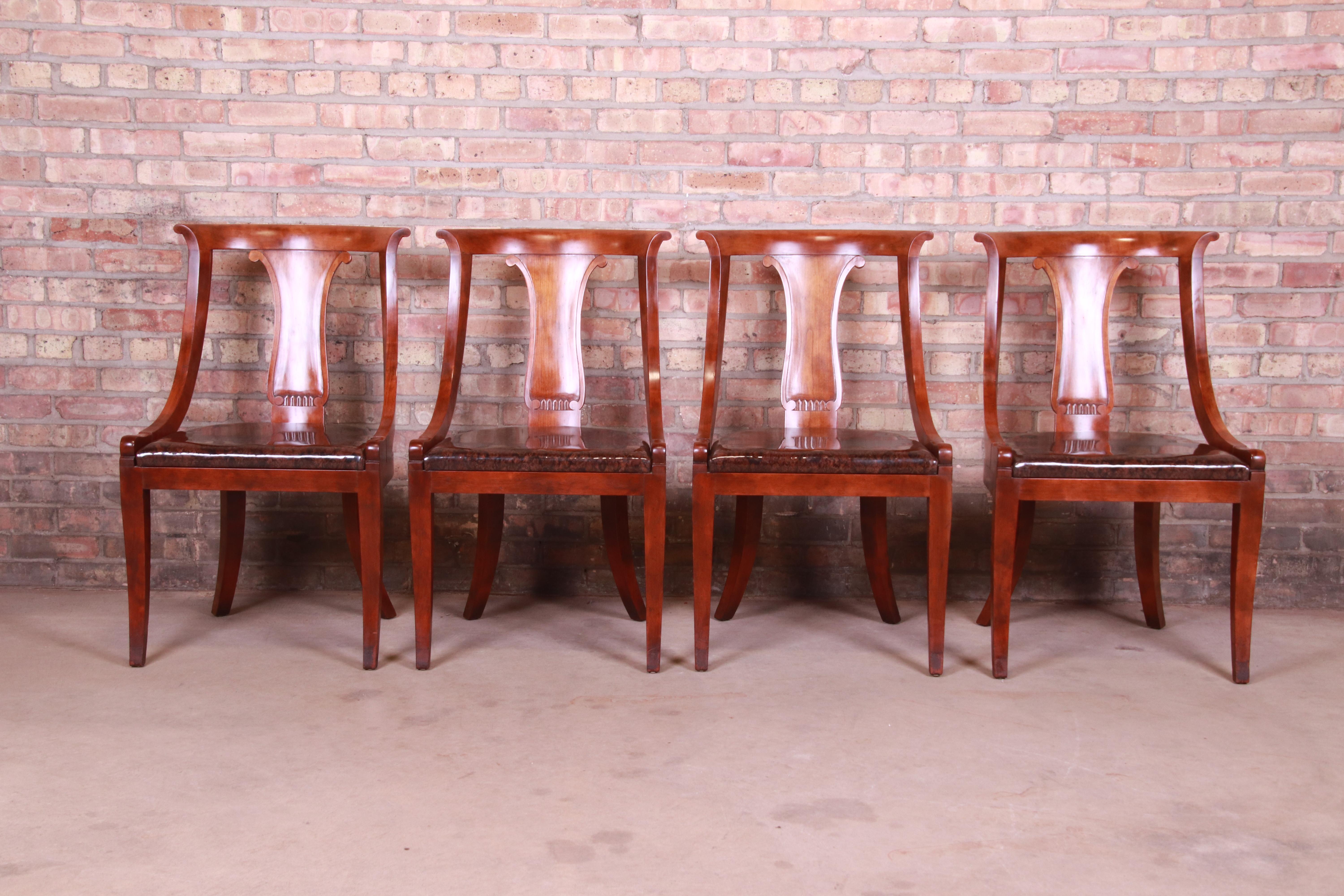 A gorgeous set of four Regency Klismos style dining chairs

By Baker Furniture

USA, 20th century

Carved mahogany frames, with brown vinyl upholstery.

Measures: 21