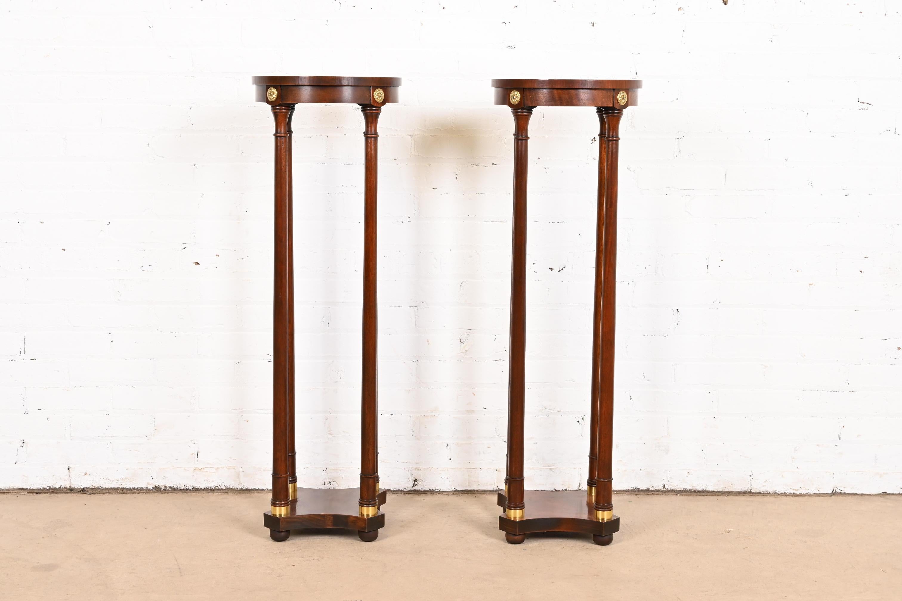 A gorgeous pair of Regency or Empire style pedestal plant stands

By Baker Furniture

USA, Circa 1980s

Beautiful carved mahogany, with brass accents.

Measures: 13