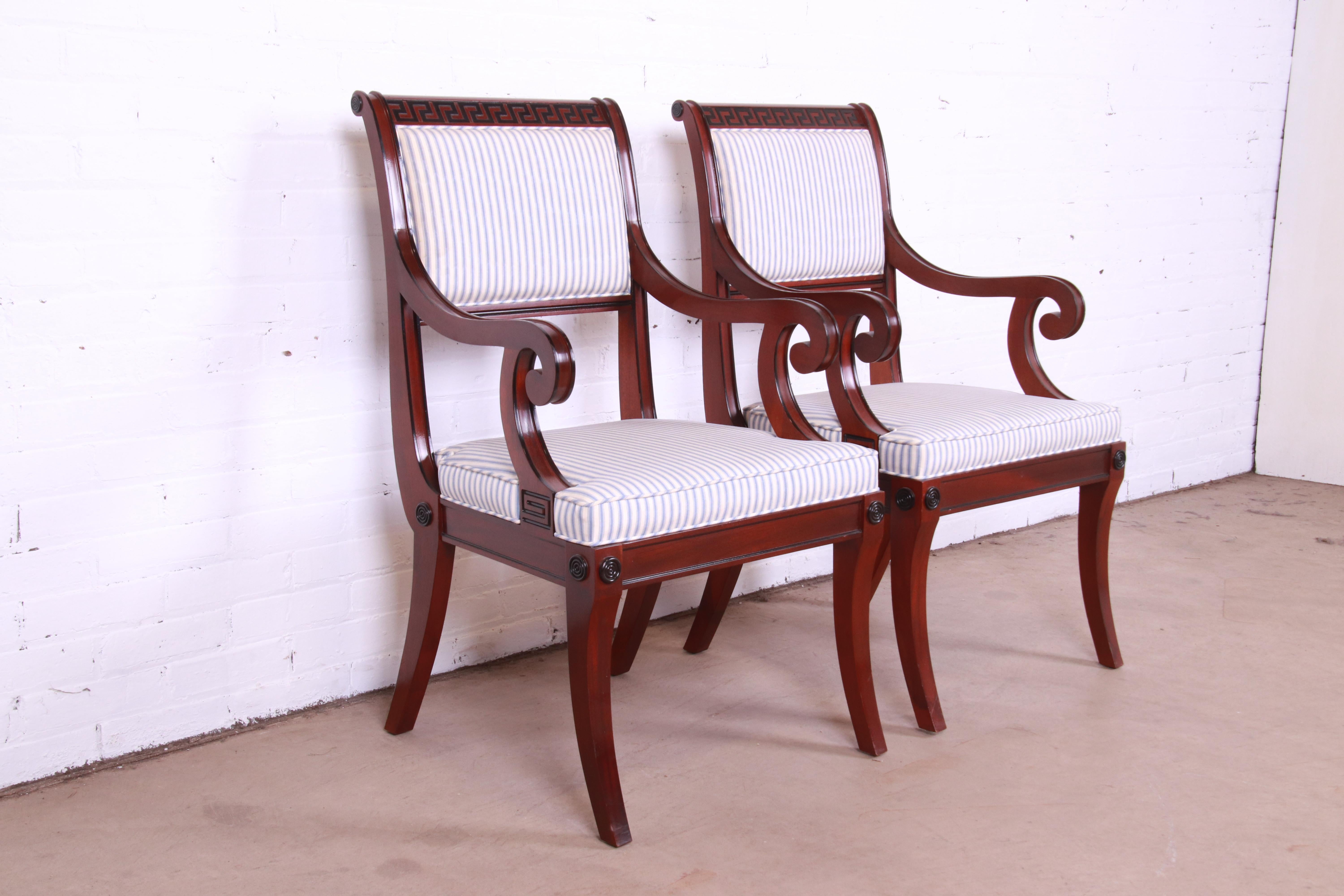 A gorgeous pair of Regency or neoclassical style club chairs or dining armchairs

By Baker Furniture

USA, late 20th century

Solid carved mahogany frames, with ebonized Greek key design, and blue & white striped upholstered