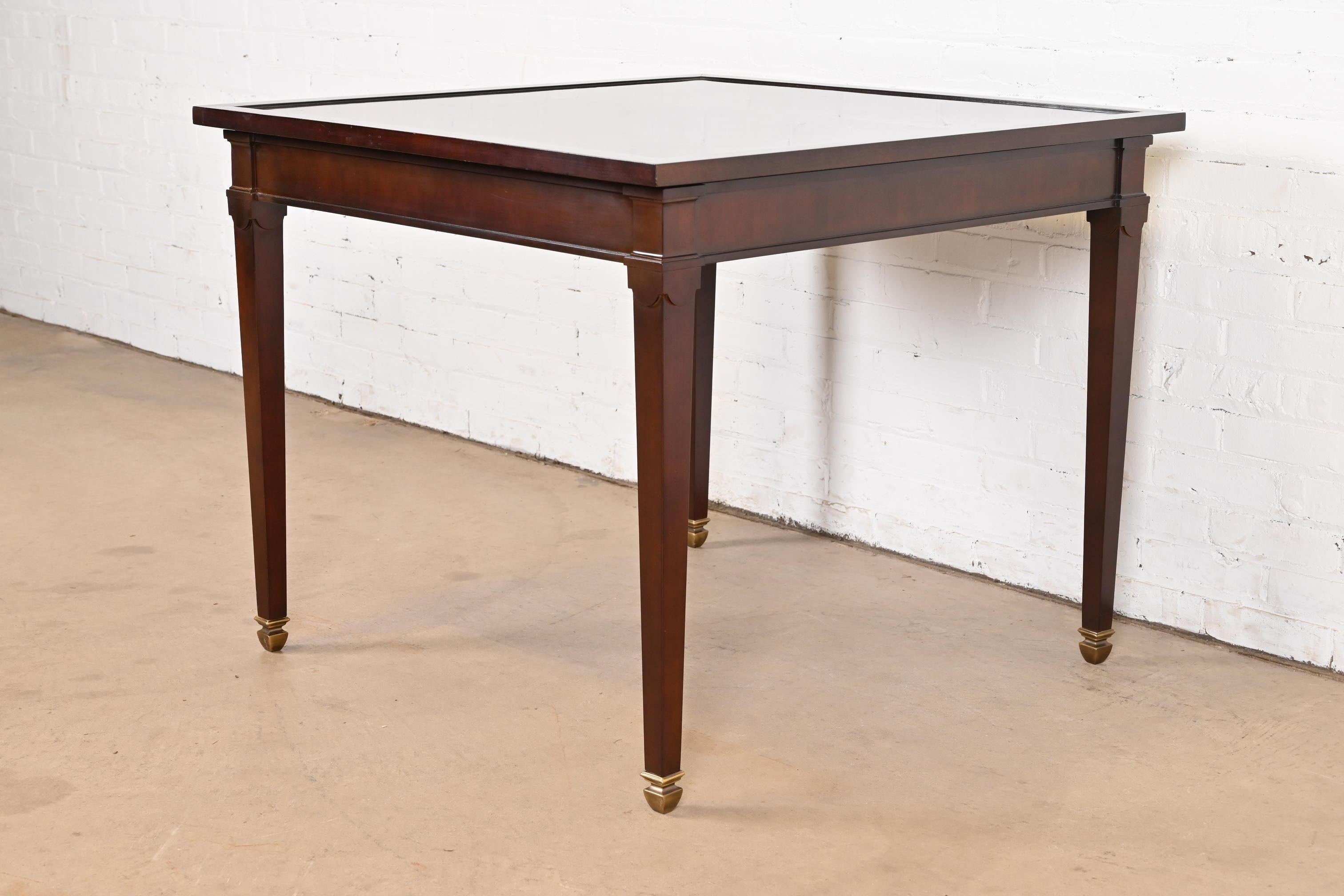 A gorgeous Regency or Georgian style game table or breakfast table

By Baker Furniture

USA, Circa Late 20th Century

Gorgeous mahogany, with parquet top, and brass-capped feet. Features felt-lined interior for silverware or game pieces and flip top