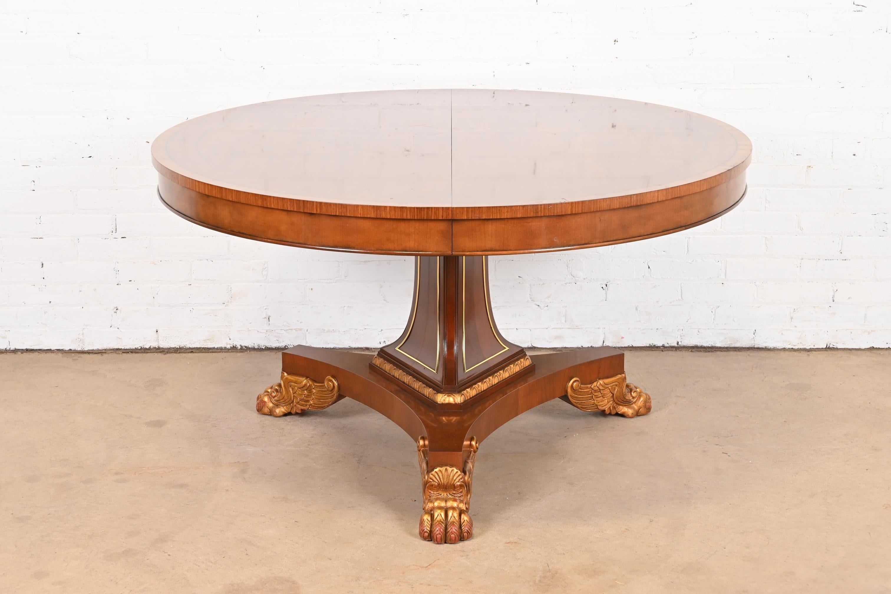 A gorgeous Empire, Regency, or Neoclassical style round pedestal breakfast table, game table, or center table

By Baker Furniture

USA, Circa 1980s

Beautiful book-matched cherry wood, with rosewood banding and ebony string inlay. The pedestal with
