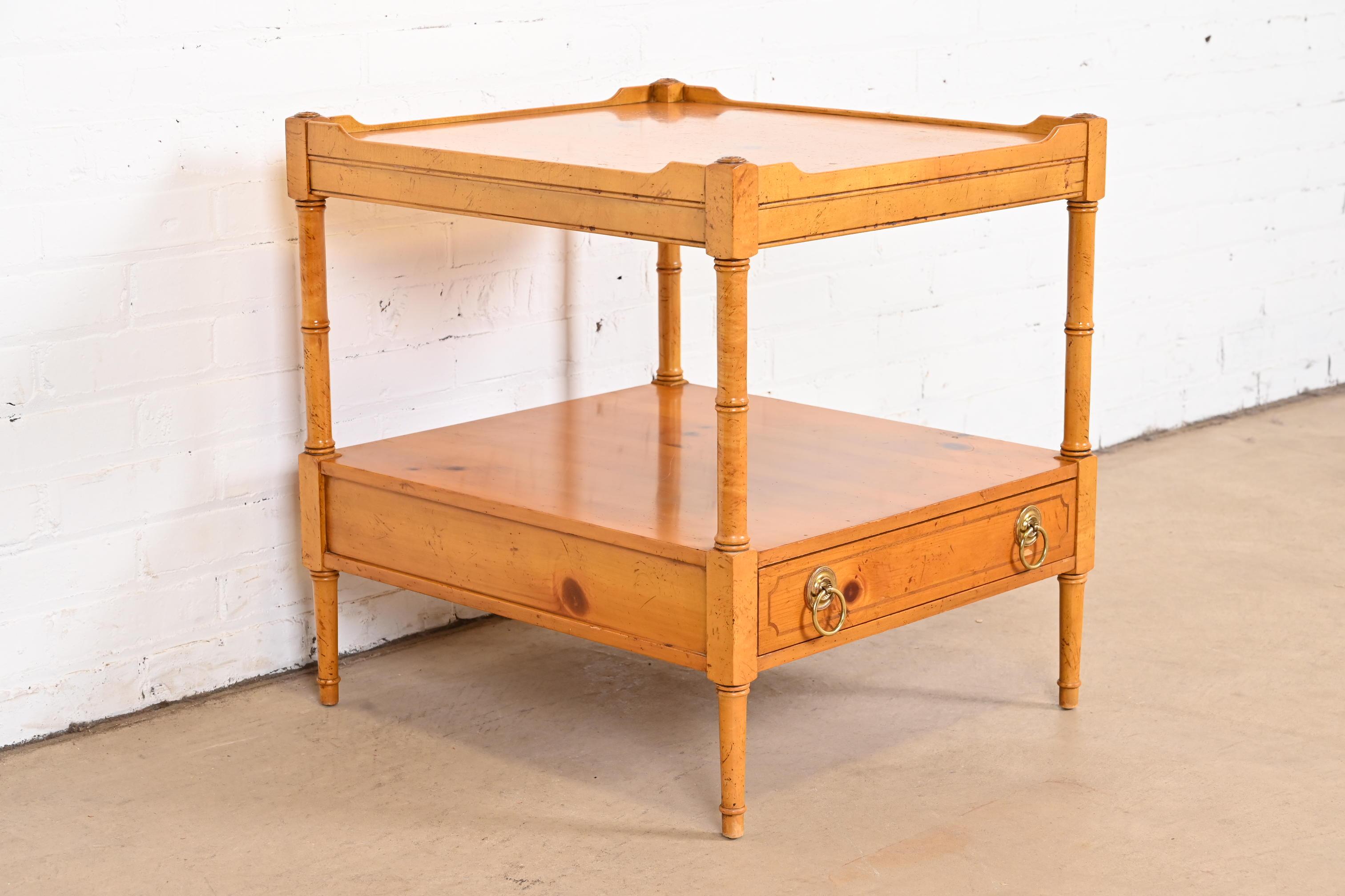 A gorgeous Regency or Rustic European style two-tier nightstand, tea table, or occasional side table

By Baker Furniture

USA, circa 1980s

Carved solid pine, with brass hardware.

Measures: 21.5