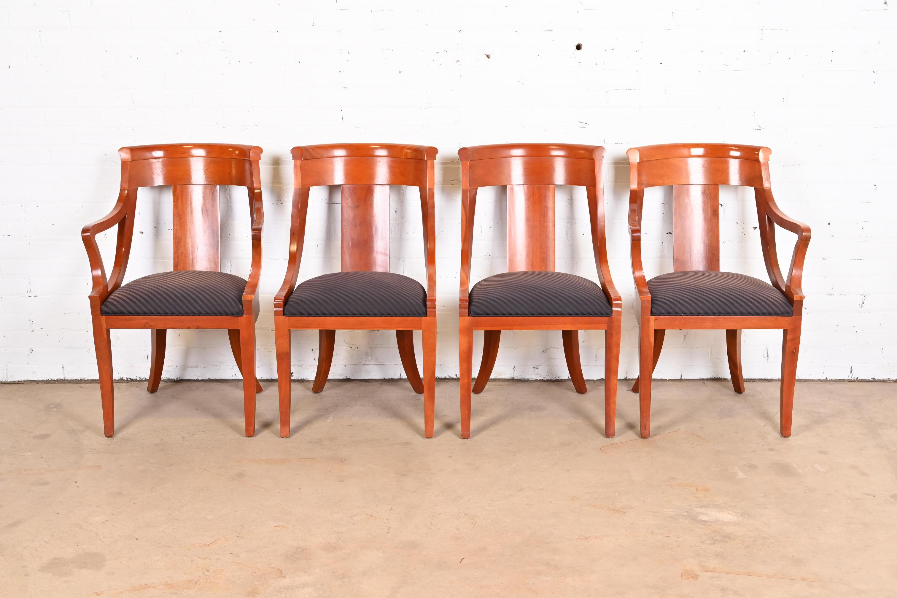 An outstanding set of four Regency or Neoclassical style dining chairs

By Baker Furniture

USA, Circa 1980s

Solid cherry wood frames, with upholstered seats.

Measures:
Side chairs - 20.75