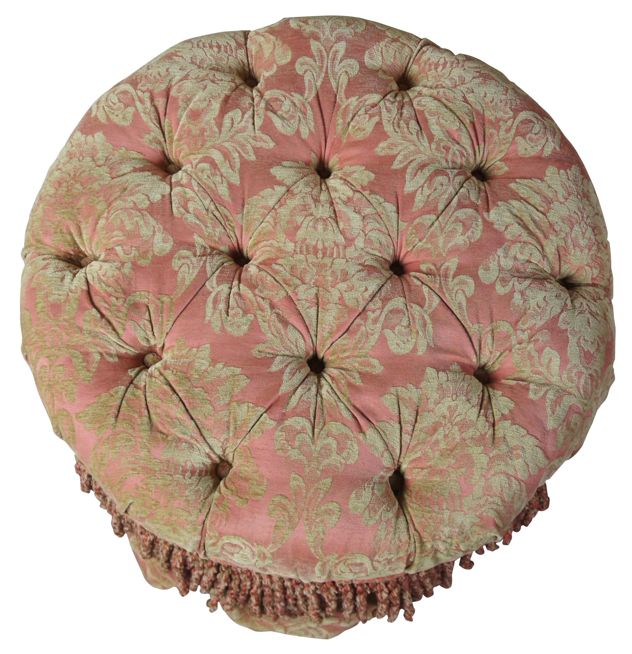 Late 20th century Baker Furniture tufted ottoman. Features a French style fabric in pink with olive green floral accents and tassels. The footstool or ottoman is supported by four tapered legs and shepard castors. GCN111.
 