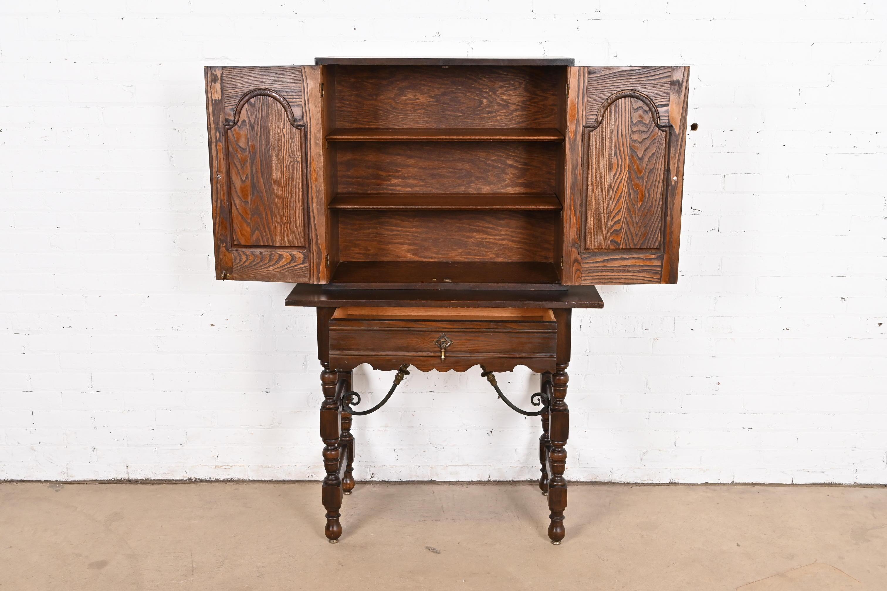 Brass Baker Furniture Spanish Colonial Carved Oak Leather Front Bookcase or Cabinet For Sale