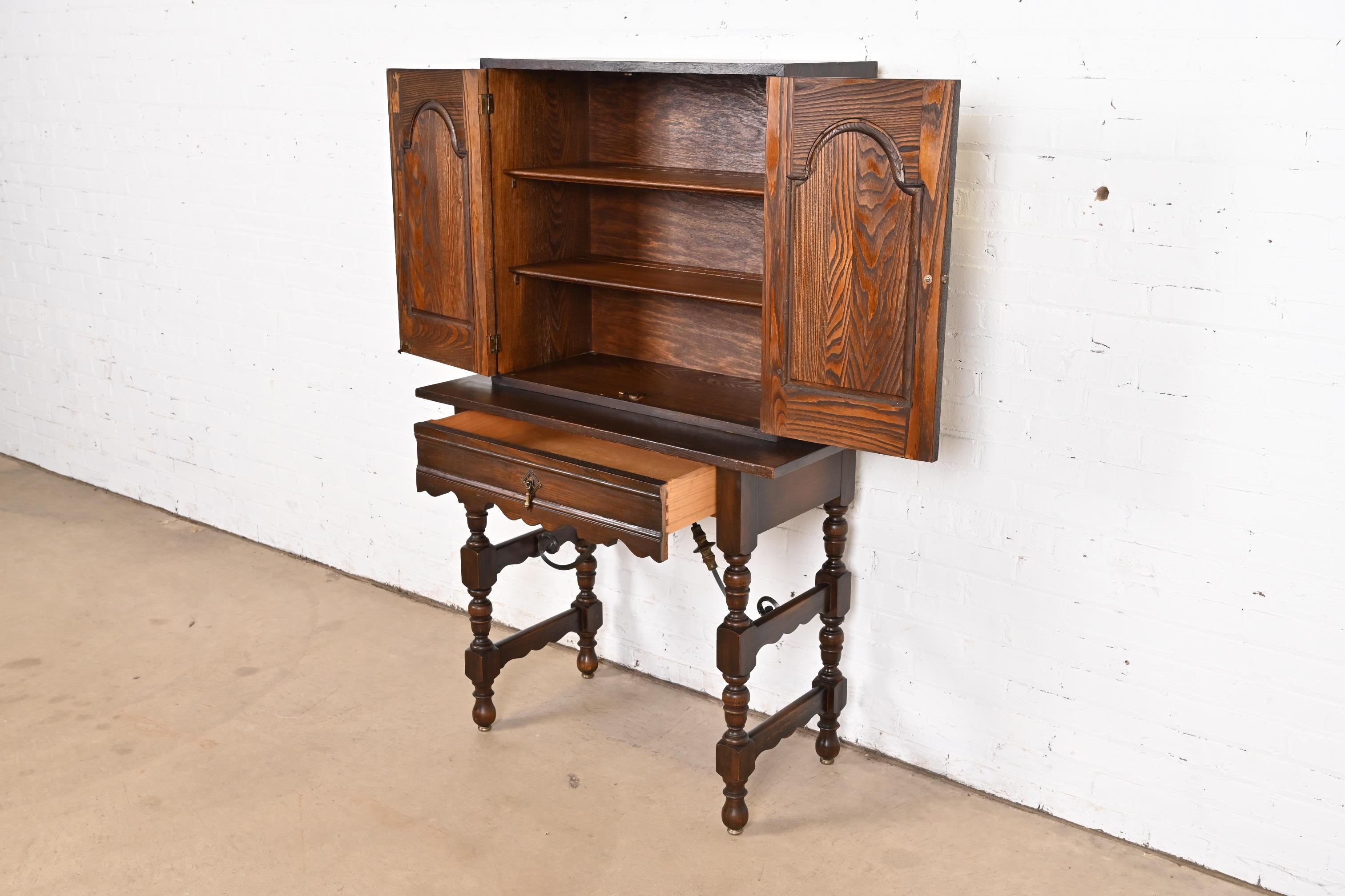 Baker Furniture Spanish Colonial Carved Oak Leather Front Bookcase or Cabinet For Sale 1