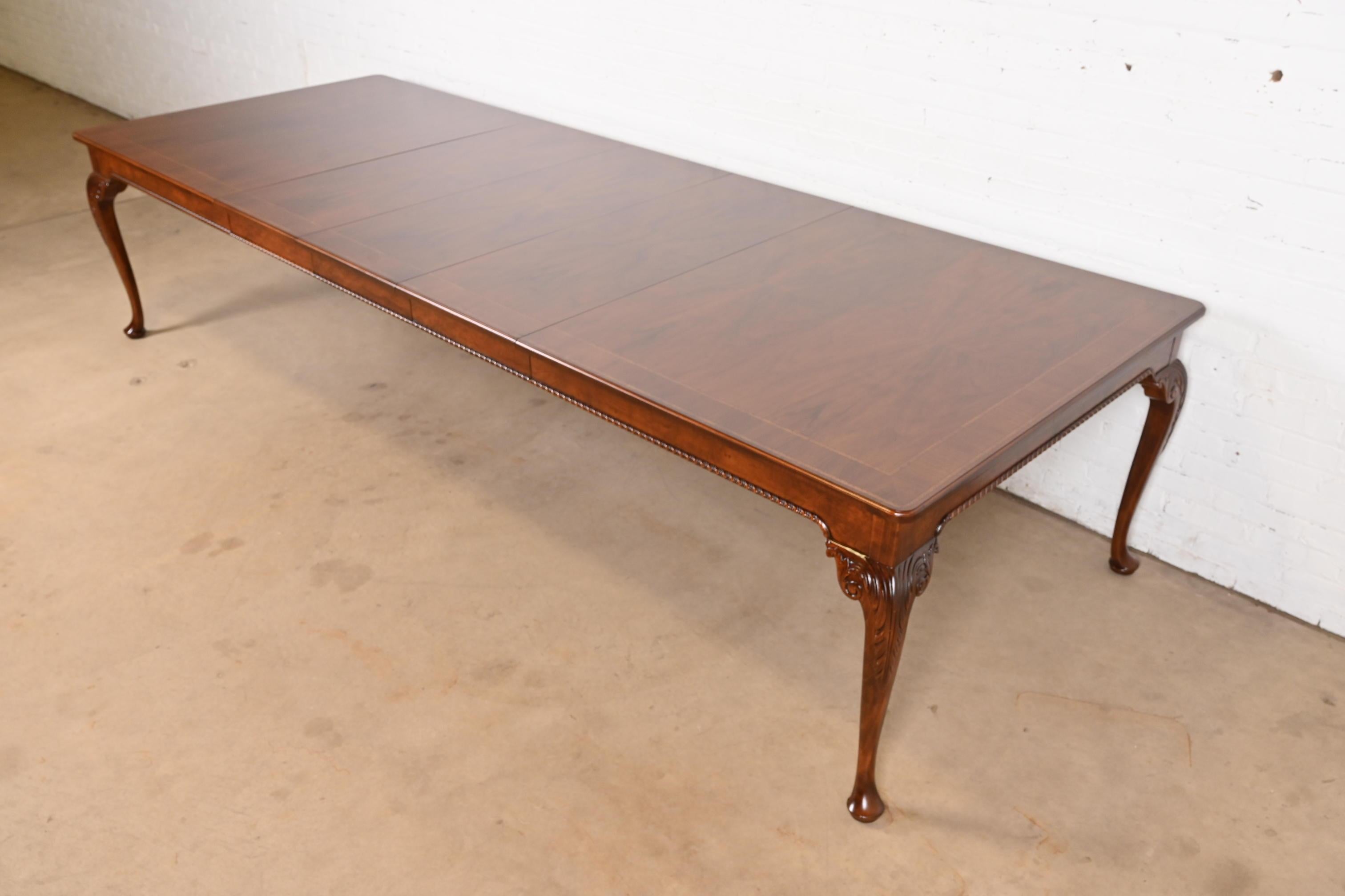 An exceptional French Provincial Louis XV style extension dining table

By Baker Furniture

USA, Circa 1960s

Beautiful book-matched walnut top, and carved cabriole legs.

Measures: 78