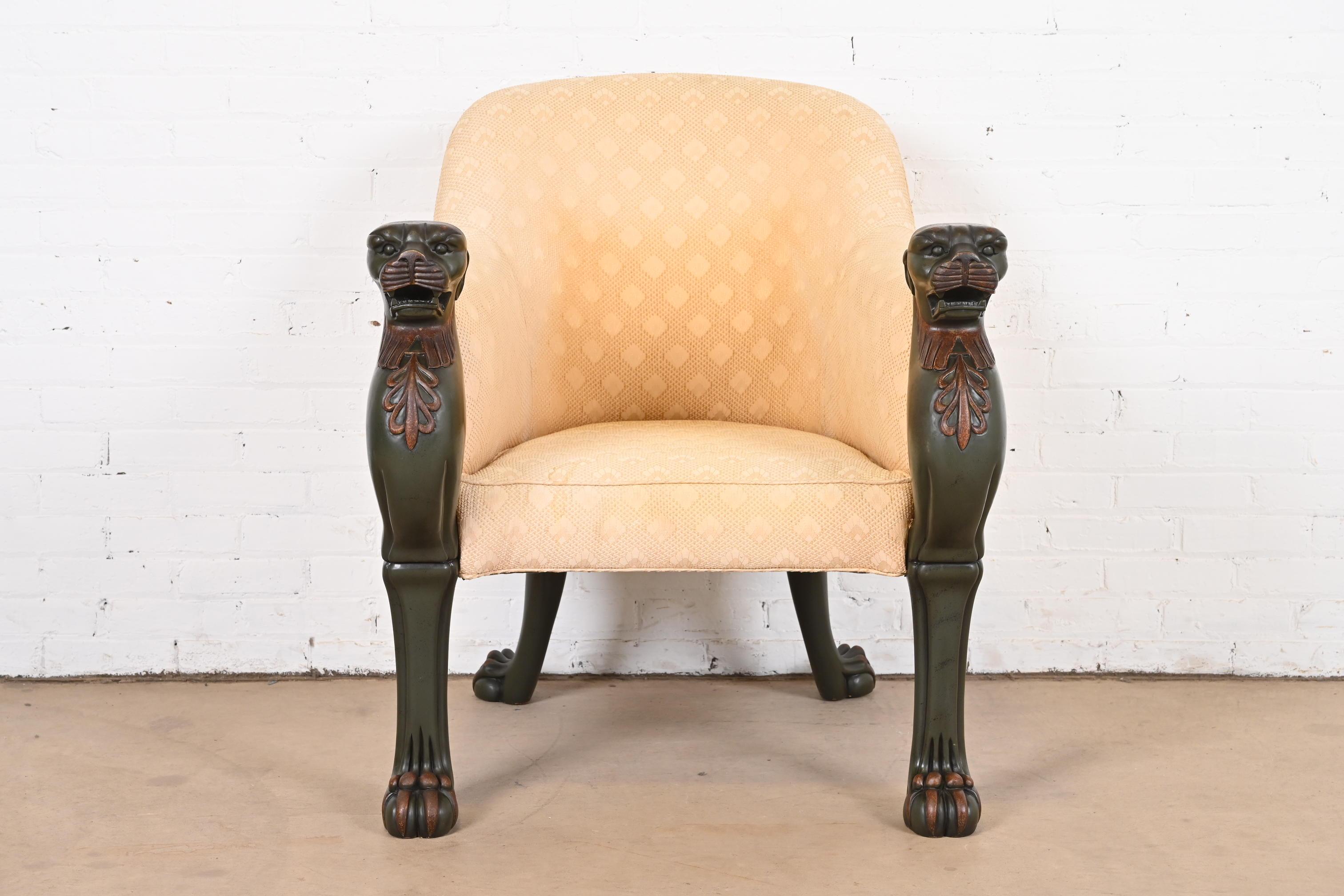 An outstanding Regency upholstered tub chair in the Egyptian style decorated in deep vert-de-bronze green and gilt. Elaborately hand-carved leopard masks continuing into lifelike clawed and padded feet. Giltwood manes and other decorated accents.