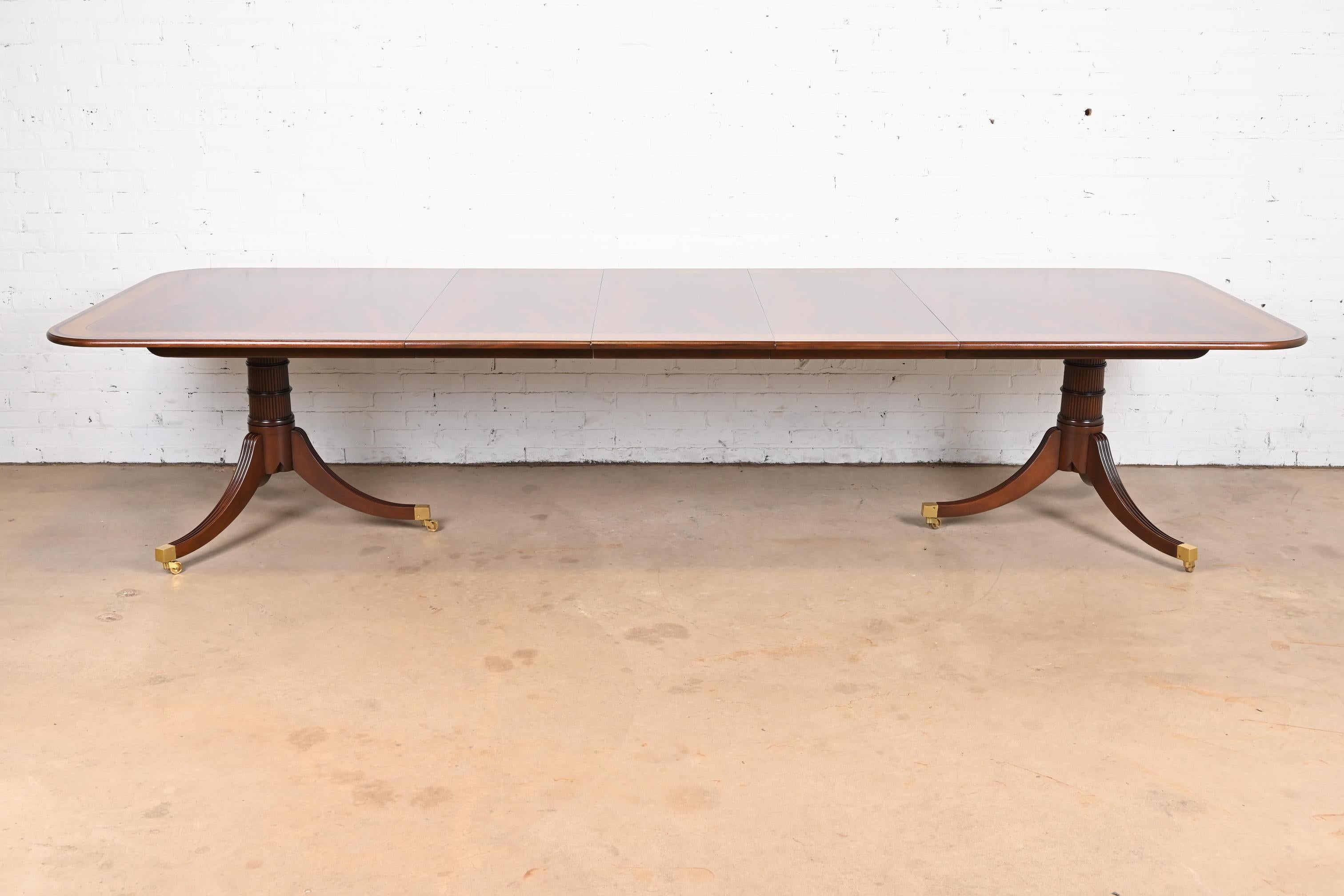 A rare and outstanding Georgian or Regency style double pedestal extension dining table

By Baker Furniture, 
