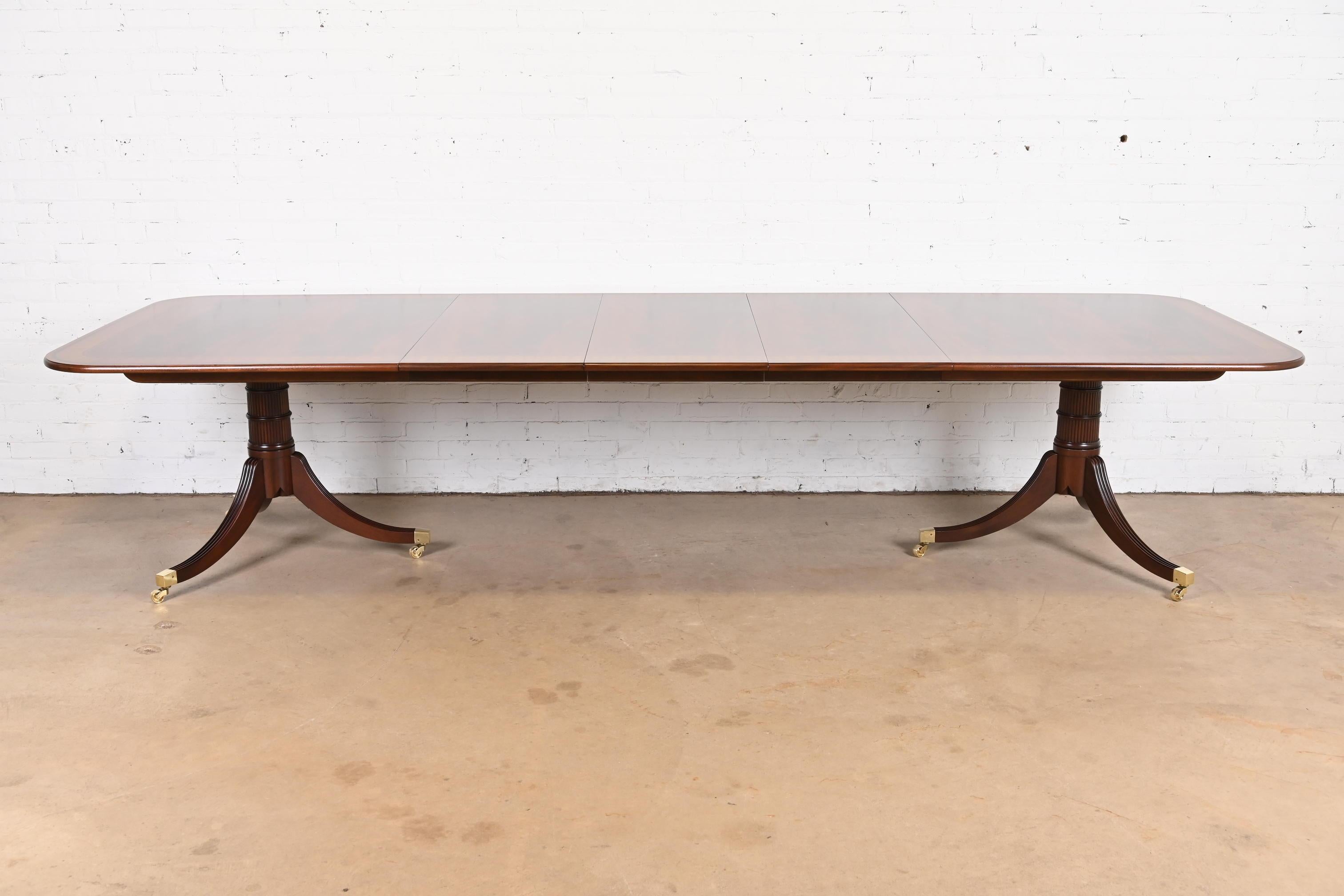 A rare and outstanding Georgian or Regency style double pedestal extension dining table

By Baker Furniture, 