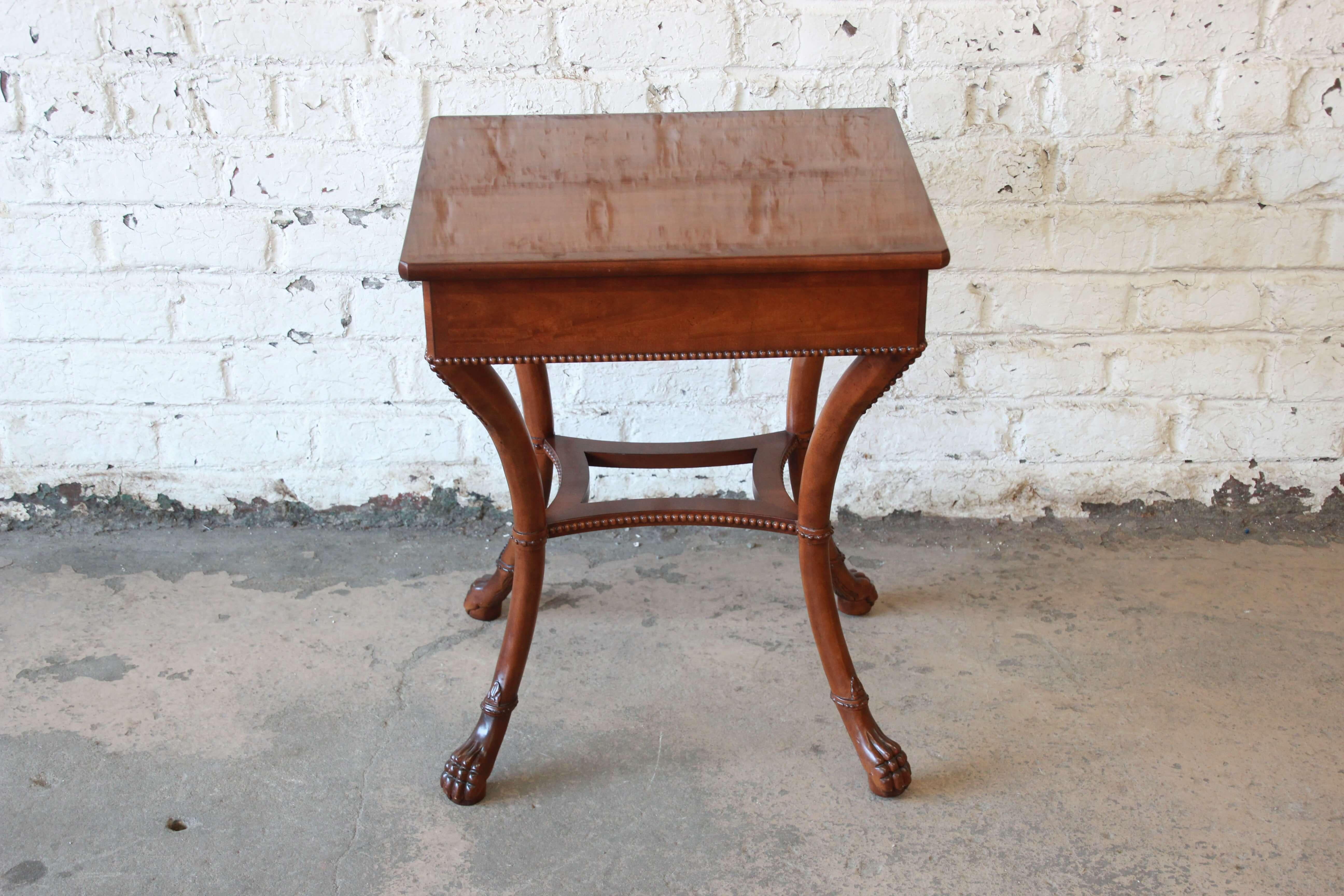 Offering a beautiful Baker Furniture Stately Homes mahogany side table. The table has very nice details with claw feet. It offers carved details throughout the piece with a nice lacquer mahogany finish on top. The table is in great original vintage