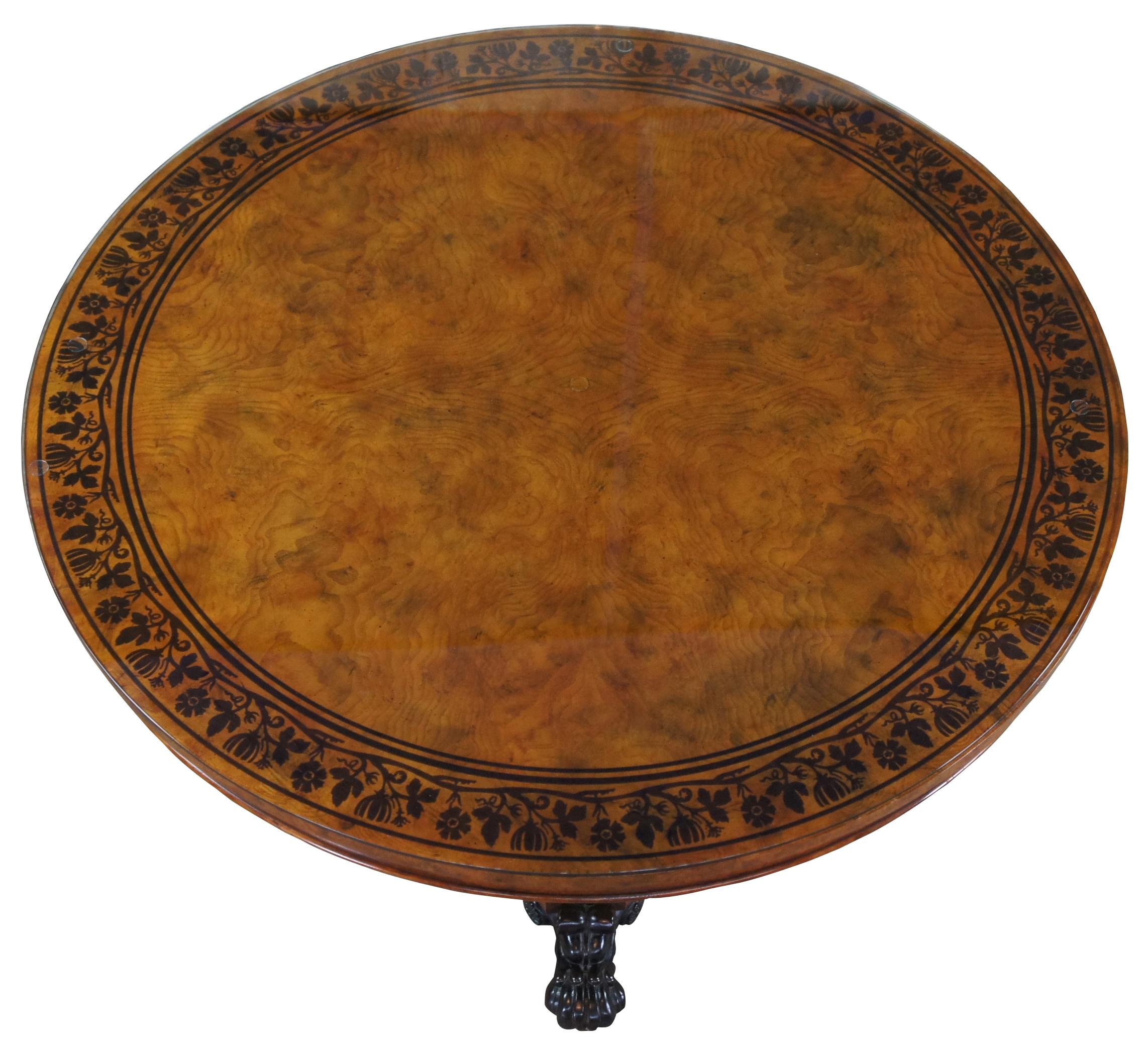 The Regency centre table, a rare piece, was designed in circular or round burr ash by George Bullock. Adorning the inlaid top is a broad border of ebonized floral vines within ebonized bands. The frieze follows suit with ebonized mouldings above a