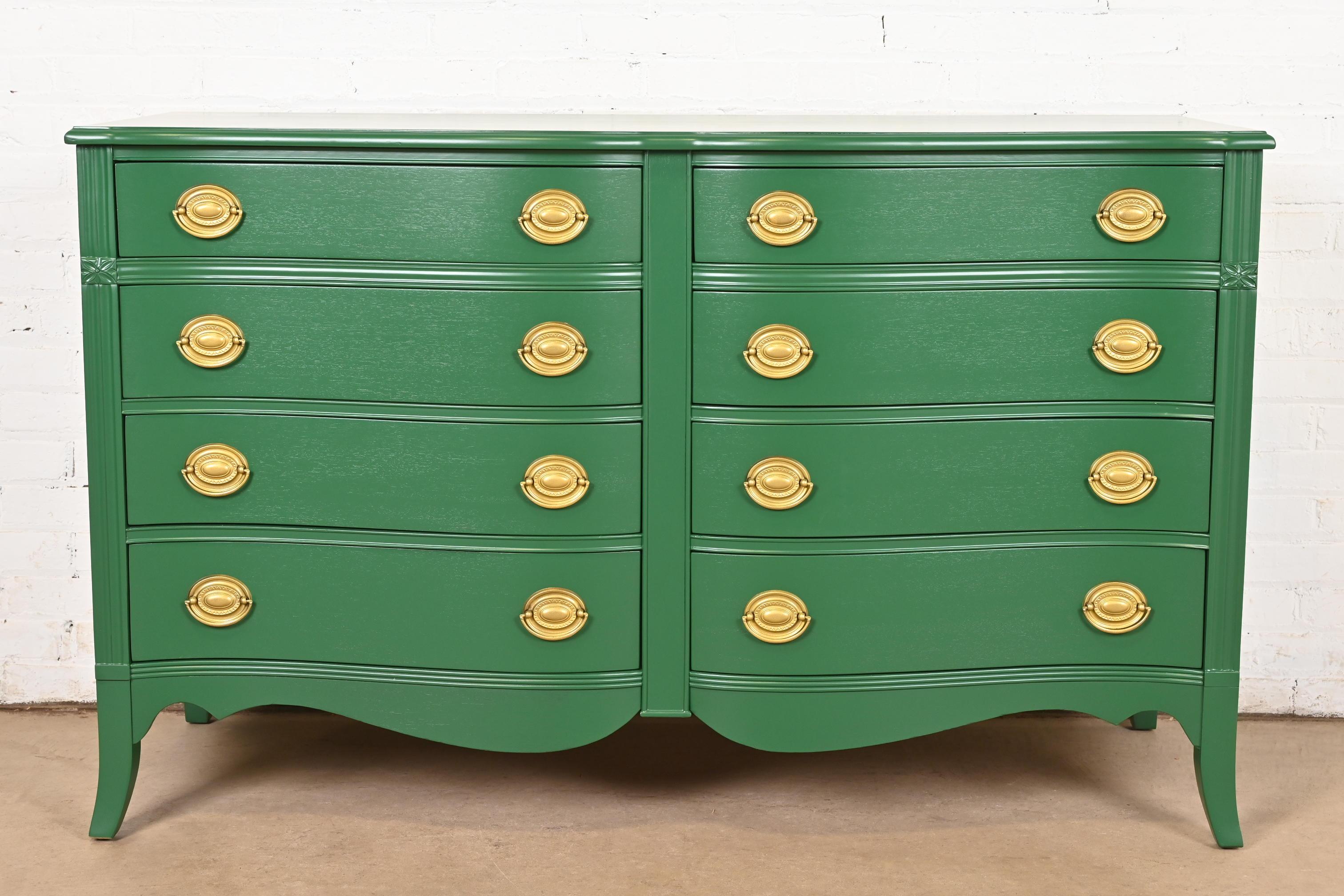 An exceptional Federal or Georgian style serpentine front eight-drawer dresser or chest of drawers

In the manner of Baker Furniture

USA, Circa 1960s

Green lacquered mahogany, with original brass hardware.

Measures: 56.5