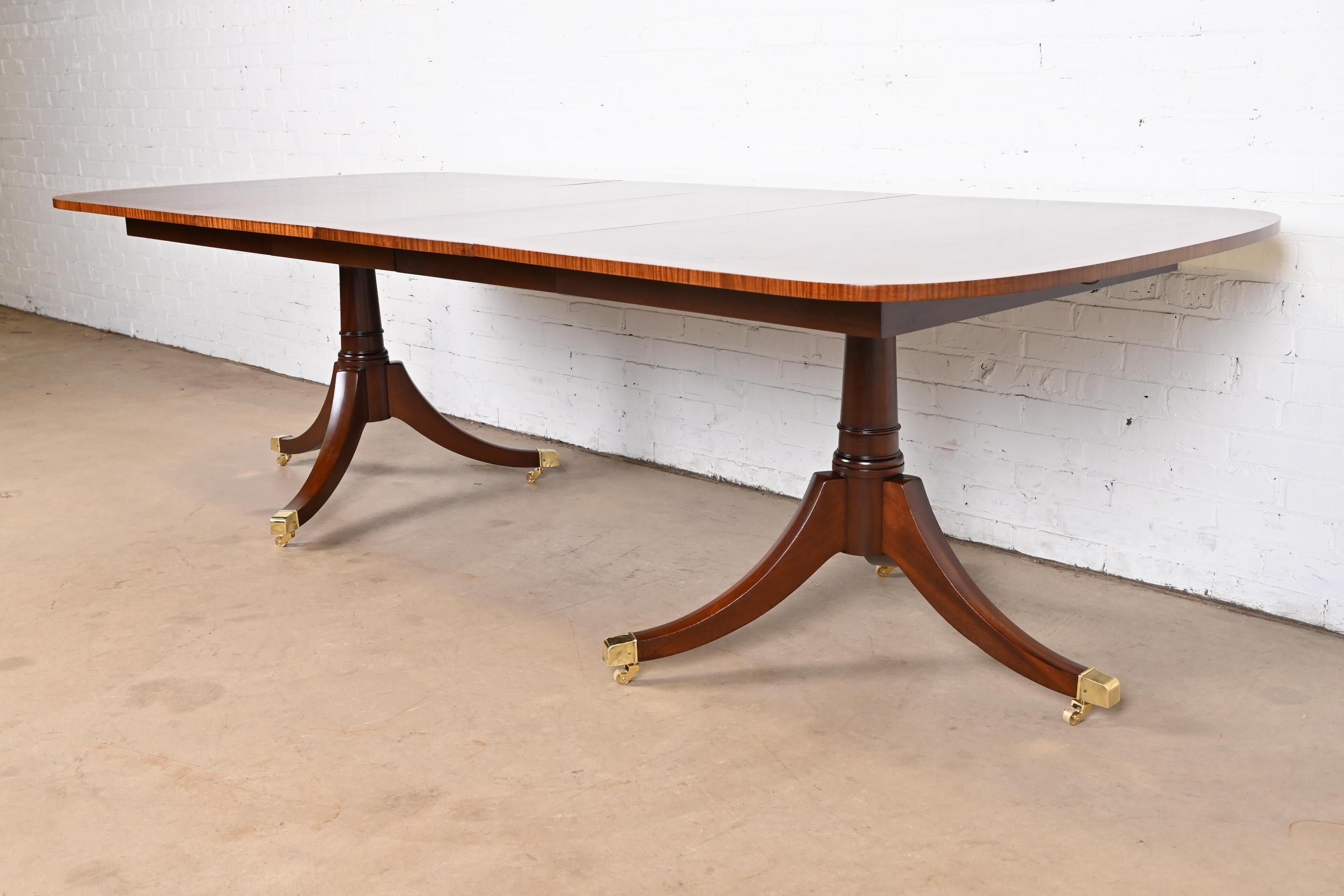 Late 20th Century Baker Furniture Style Georgian Banded Mahogany Double Pedestal Dining Table For Sale