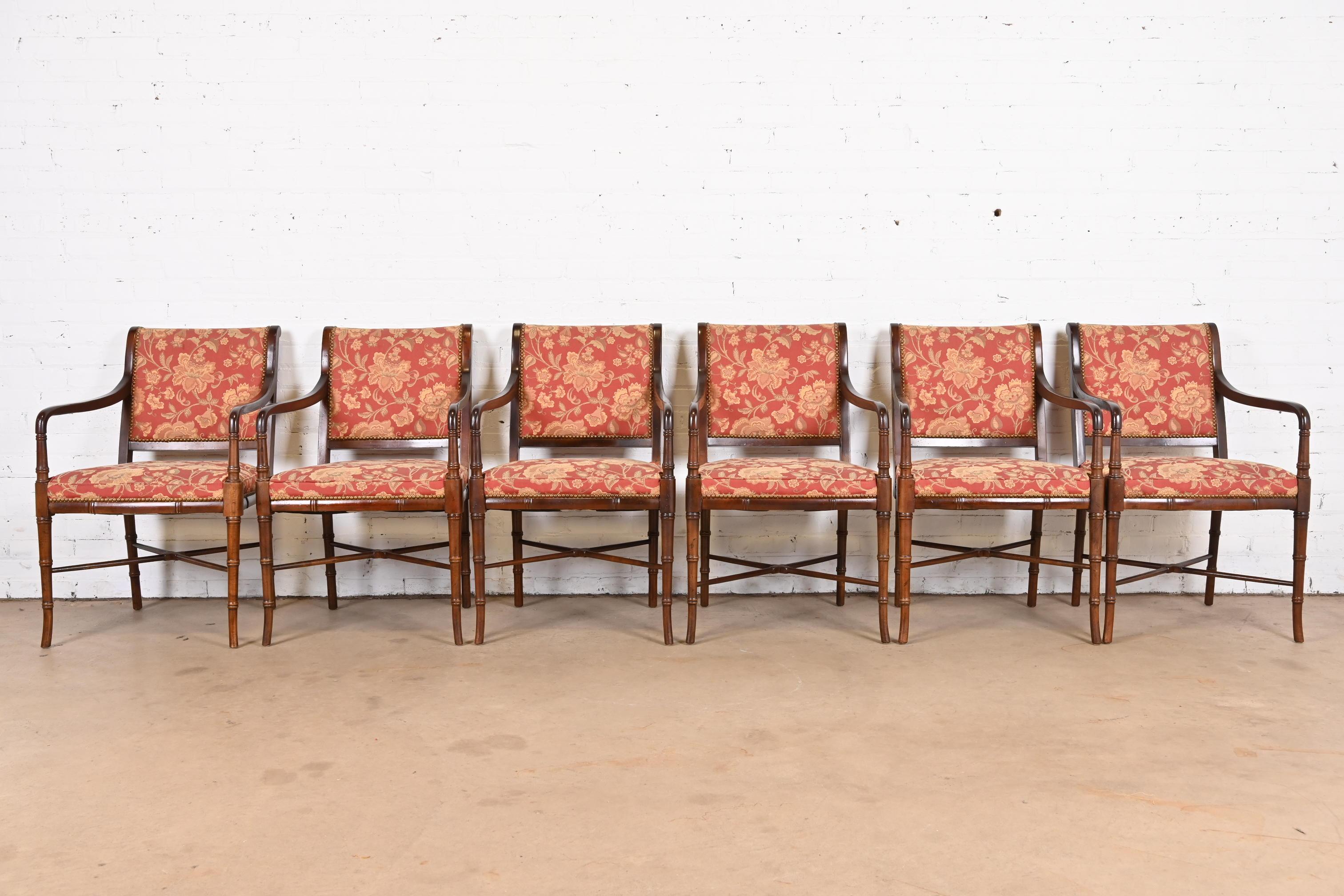 A gorgeous set of six Regency style dining armchairs

In the manner of Baker Furniture

By Southwood

USA, Late 20th Century

Faux bamboo walnut frames, with brass studded upholstered seats and back in a floral patterned fabric.

Measures: 22