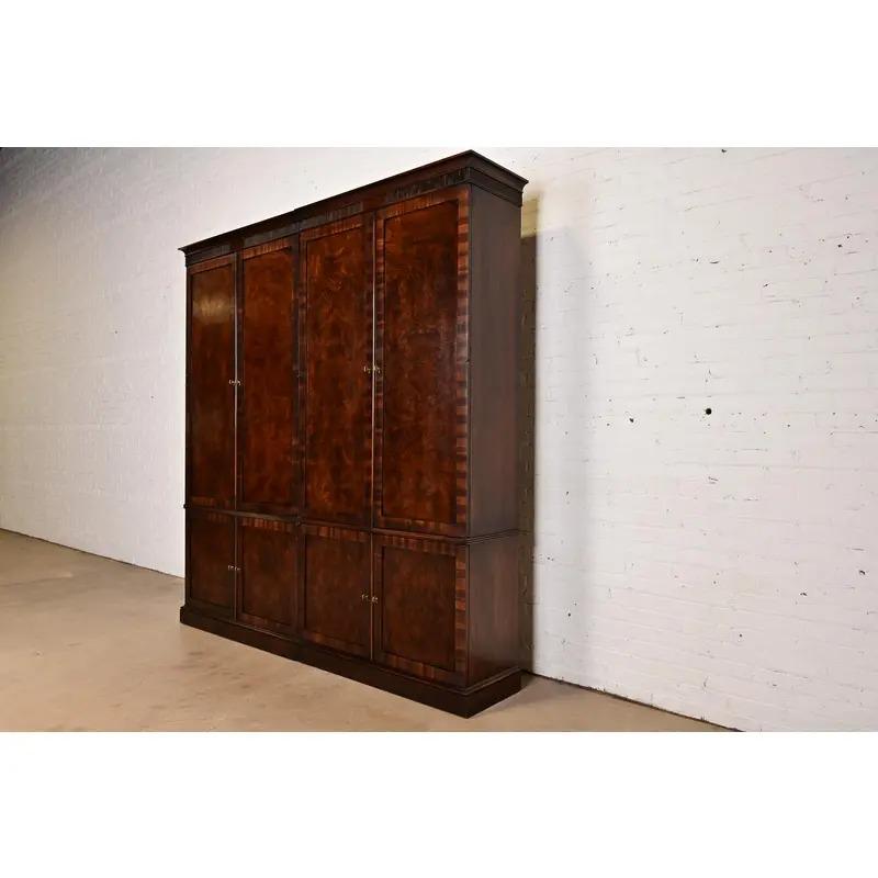 A gorgeous Regency or Georgian style gentleman's chest, armoire dresser, or linen press

In the manner of Baker Furniture

USA, Circa Late 20th Century

Carved mahogany and burl wood, with original brass hardware.

Measures: 87.5