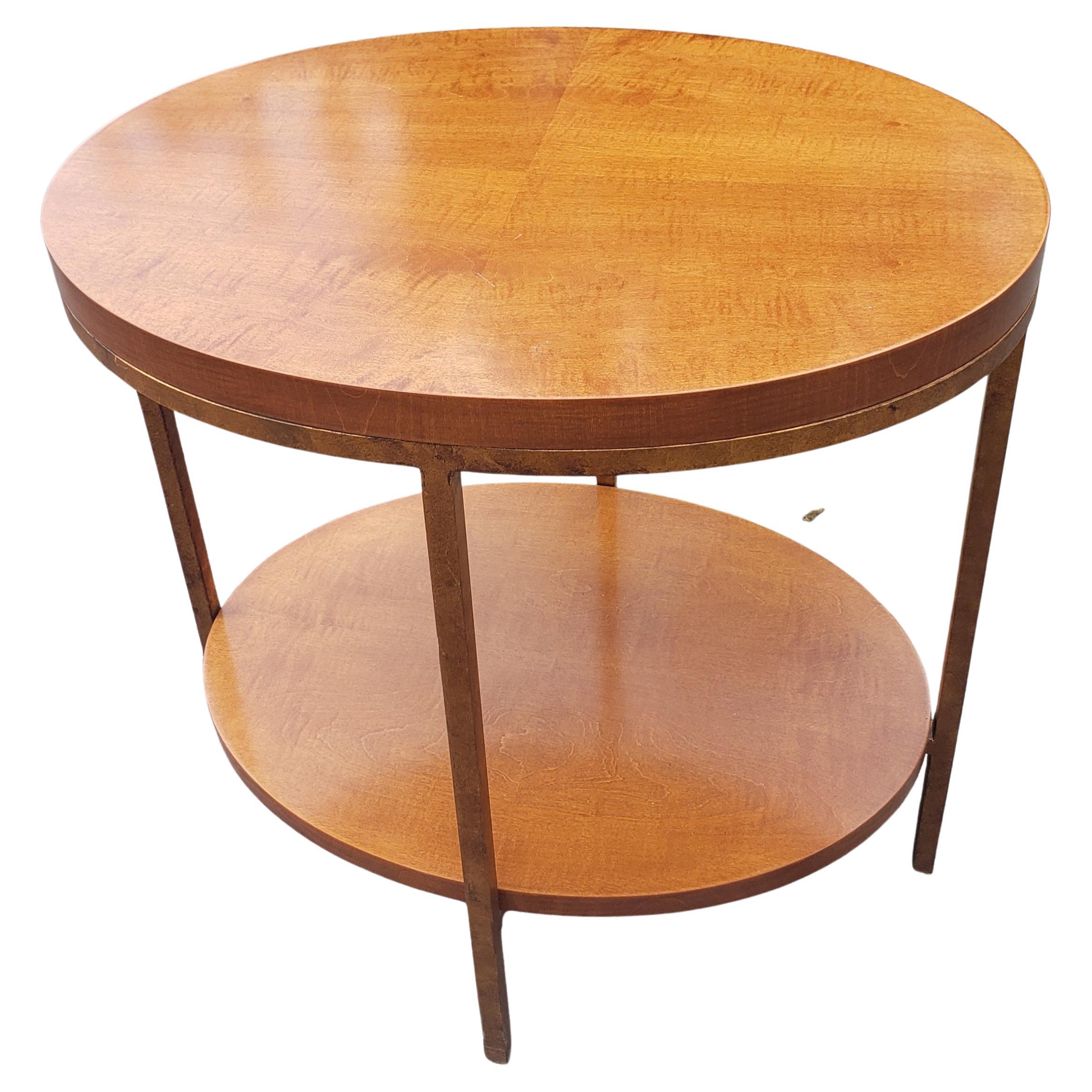 A stylish contemporary two tier oval table by Baker Furniture in primavera mahogany(blonde mahogany) and gilt metal frame. The table features an extremely heavy, sturdy and gorgeous with
Bookmached wood grain. The original Baker label is present.
