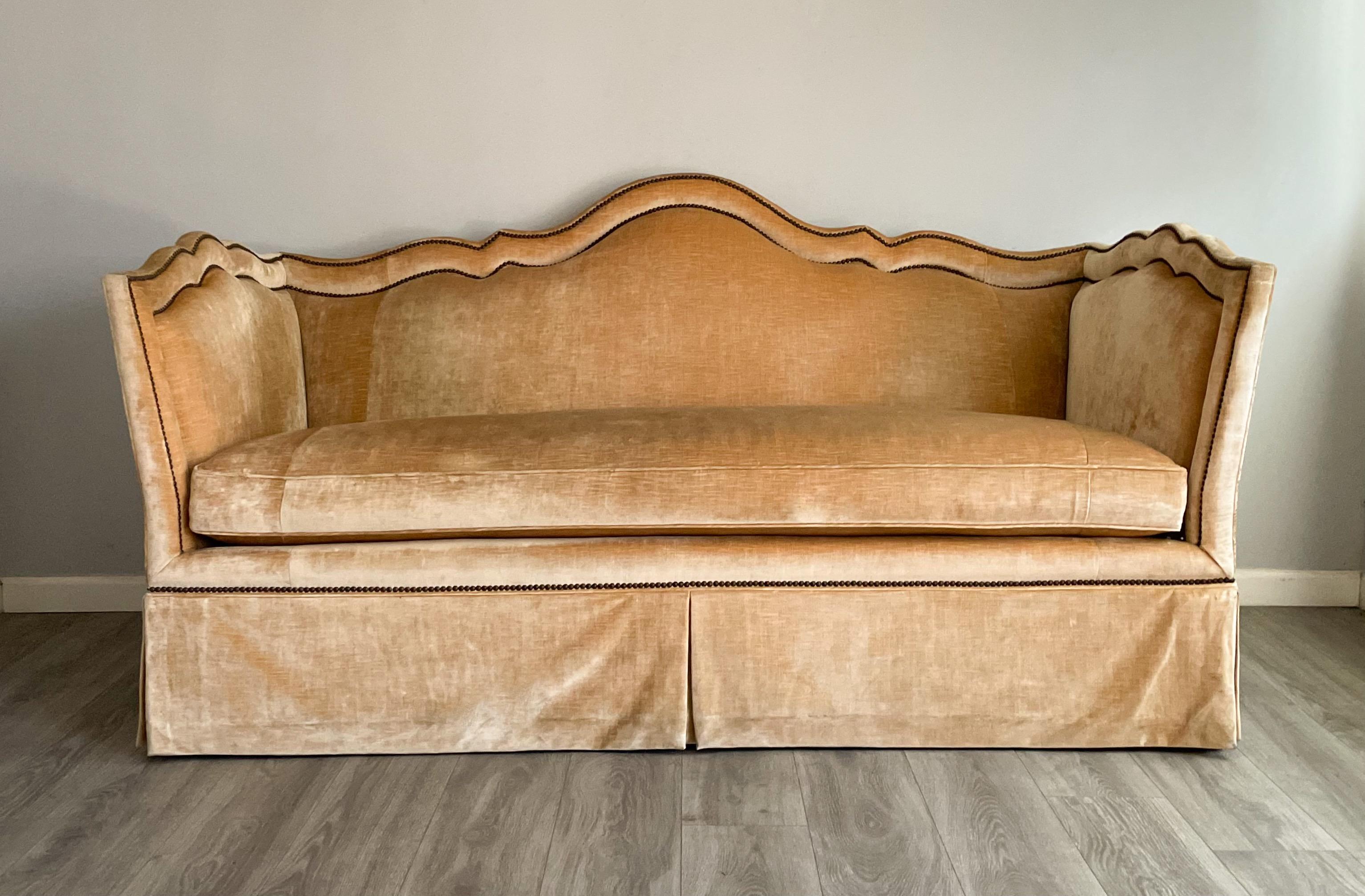 Gorgeous, golden velvet sofa with antiqued brass nailhead trim and goose-down loose seat cushion by Baker Furniture. 

Excellent pre-owned condition with minor wear and blemishes from use. 

