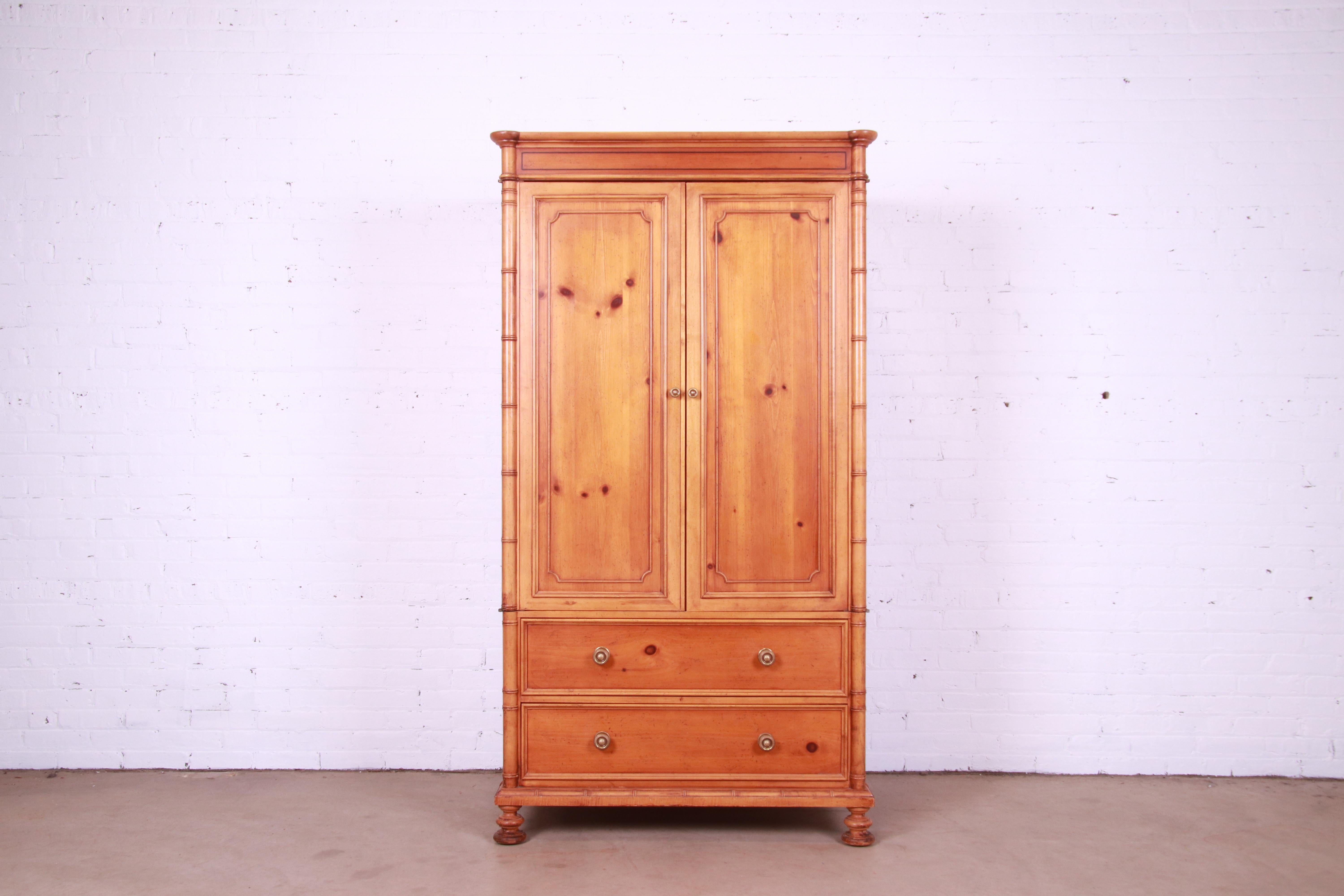 A gorgeous Victorian style armoire dresser, gentleman's chest, or linen press

By Baker Furniture

USA, Circa 1980s

Natural pine and faux bamboo, with cherry wood interior and original brass hardware.

Measures: 40.25