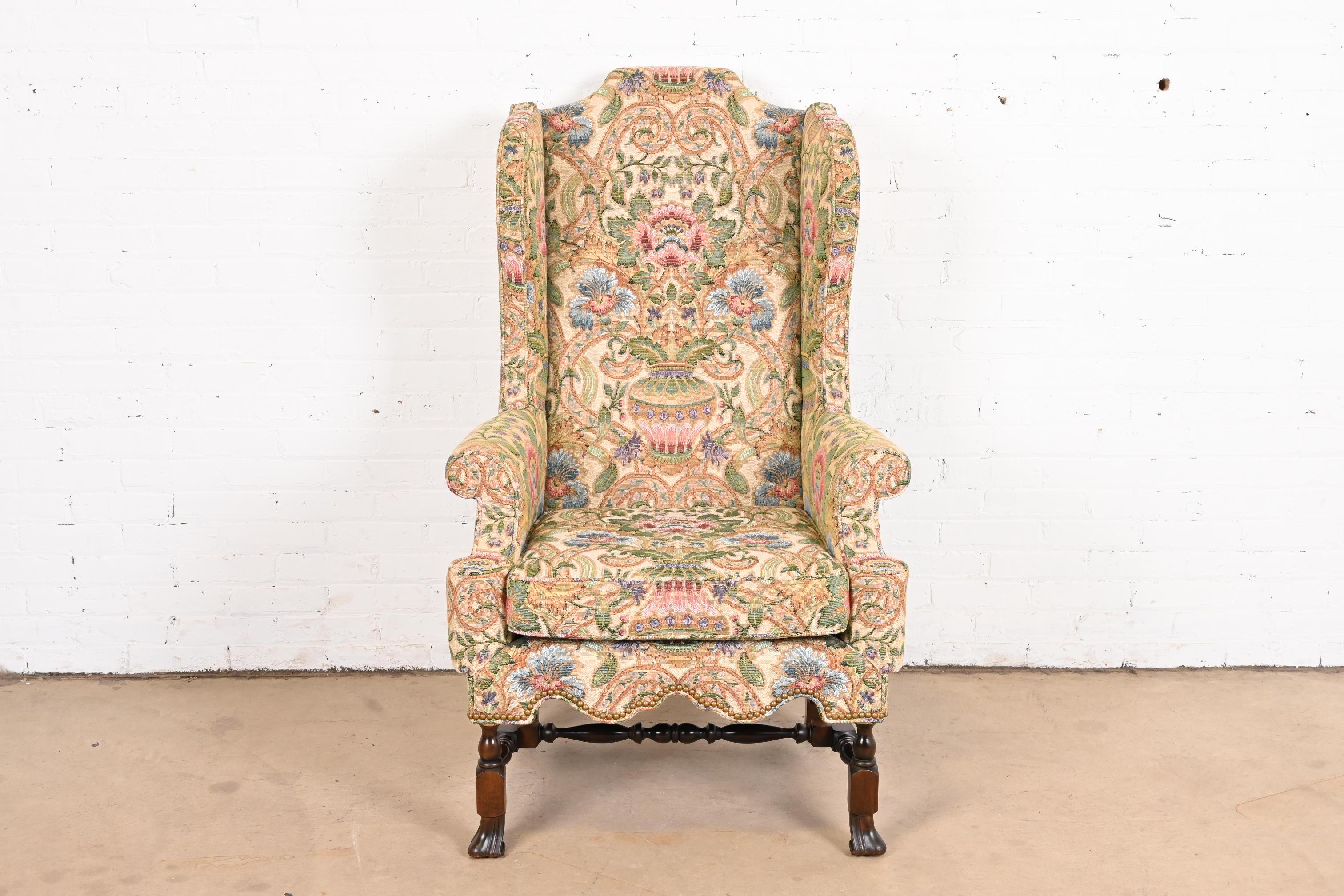 An outstanding William and Mary or Queen Anne style wingback library chair

By Baker Furniture

USA, circa 1980s

Gorgeous original custom floral upholstery, with carved walnut legs and stretchers.

Measures: 30.5