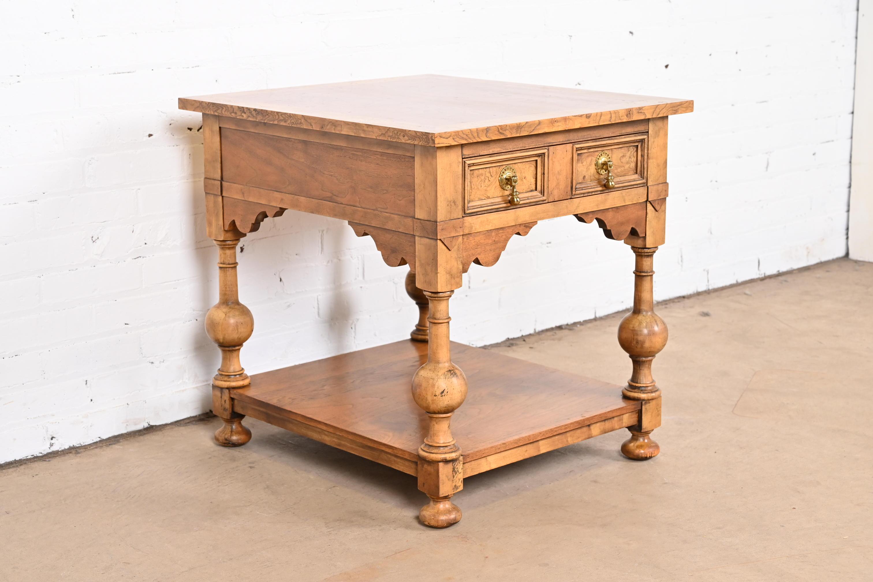 A gorgeous William and Mary style single drawer nightstand, tea table, or occasional side table

By Baker Furniture

USA, Circa 1960s

Book-matched walnut top, carved solid walnut legs, burl wood drawer front and banding, and original brass