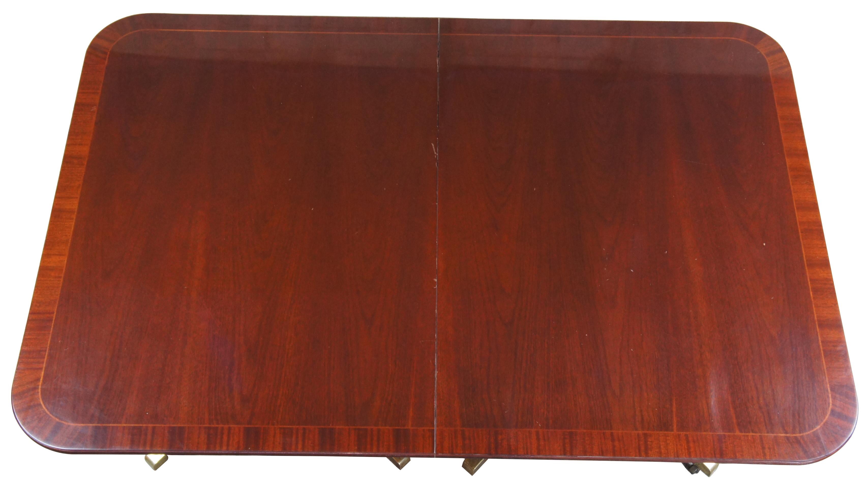 Baker Historic Charleston Duncan Phyfe double pedestal mahogany dining table

Baker Furniture Historic Charleston dining table, circa 1980s. Features Duncan Phyfe styling with a double pedestal supporting a banded mahogany top. Includes fluted