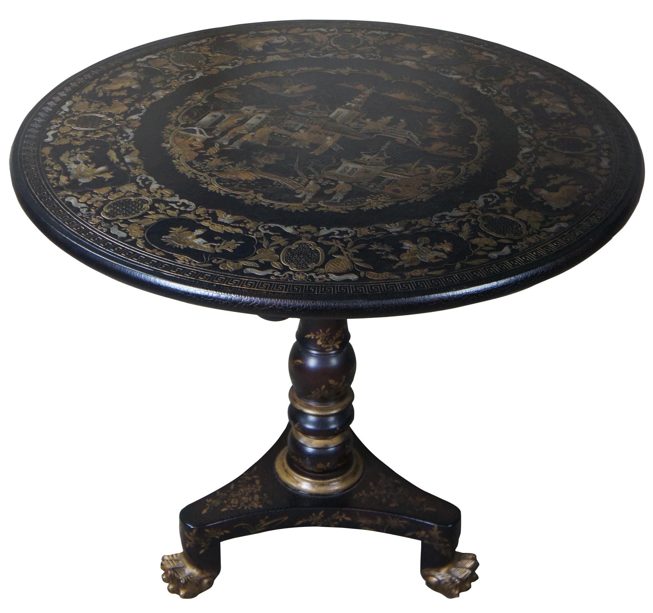 Baker Furniture Company Historic Charleston Japanned tilt-top tea table, in the Regency or Empire style. Features a circular top with embossed gilt landscape and figural decoration, a secondary band of embossed gilt foliate and figural vignette