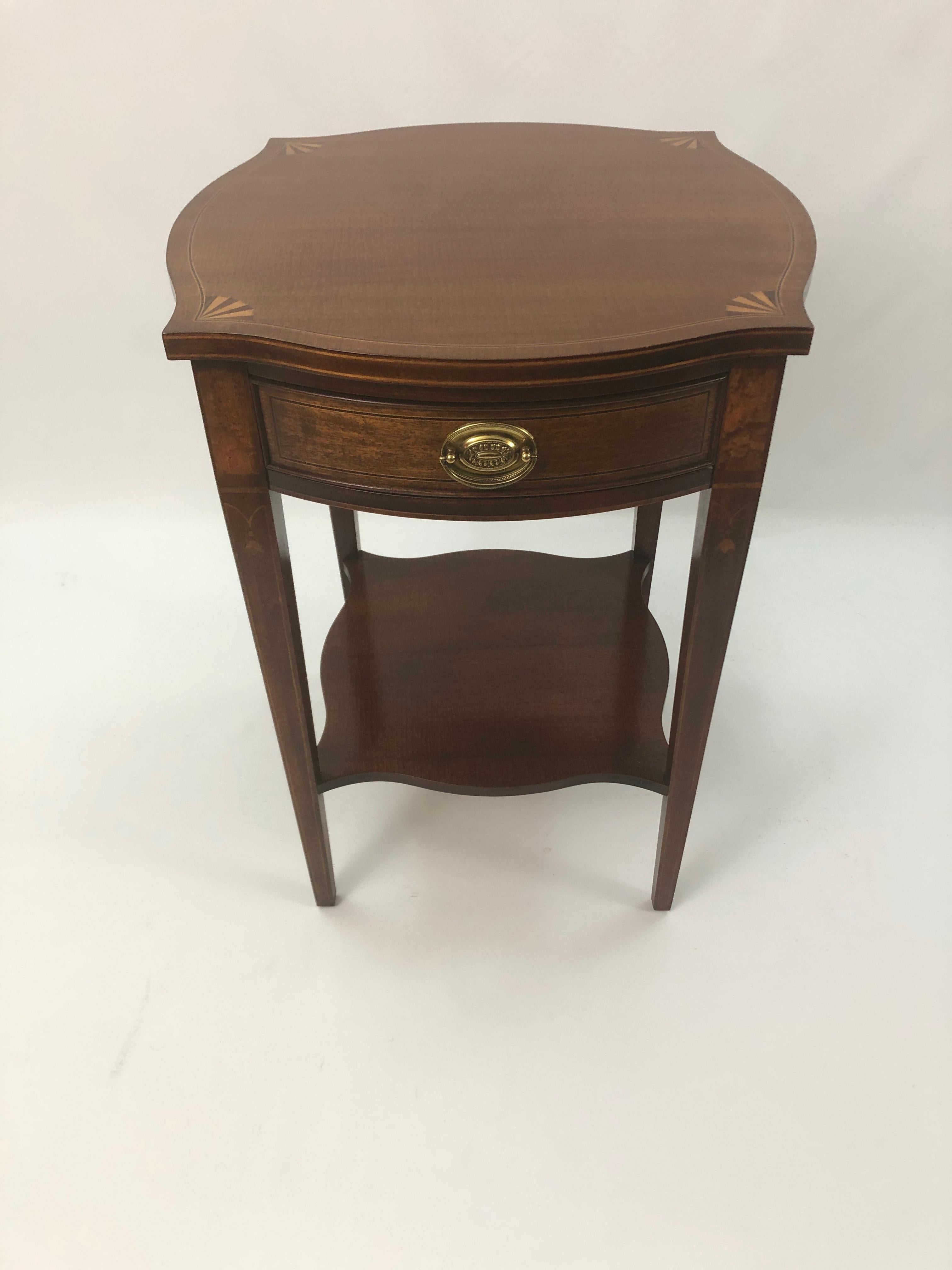 Classic mahogany and satinwood inlay side table with pretty pointed corners and fan design, tapered legs with bellflower decoration, and single drawer.