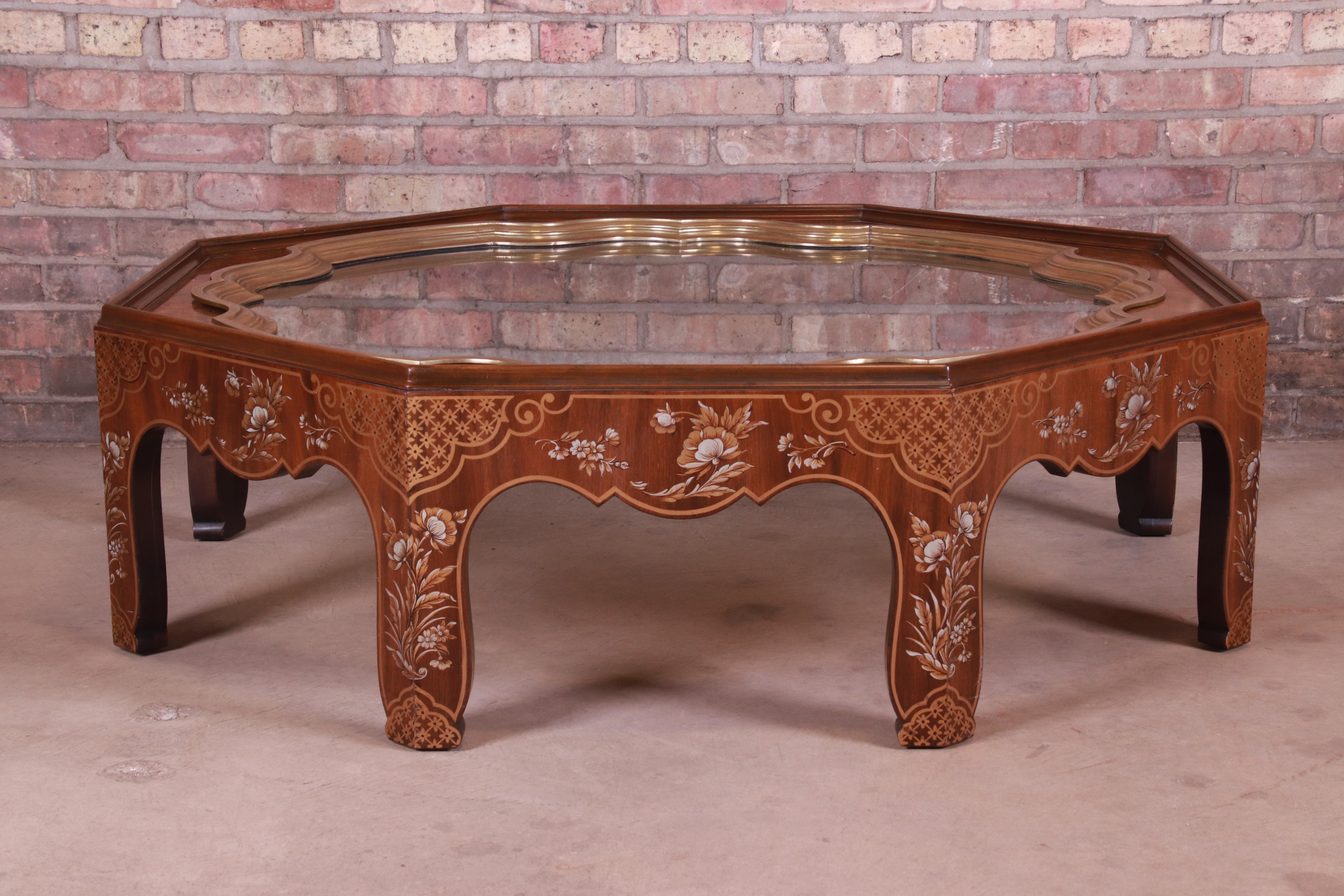 A gorgeous Hollywood Regency chinoiserie coffee or cocktail table

By Baker Furniture

USA, circa 1970s

Walnut with hand painted Asian designs in floral motif, brass-mounted glass top.

Measures: 48.5