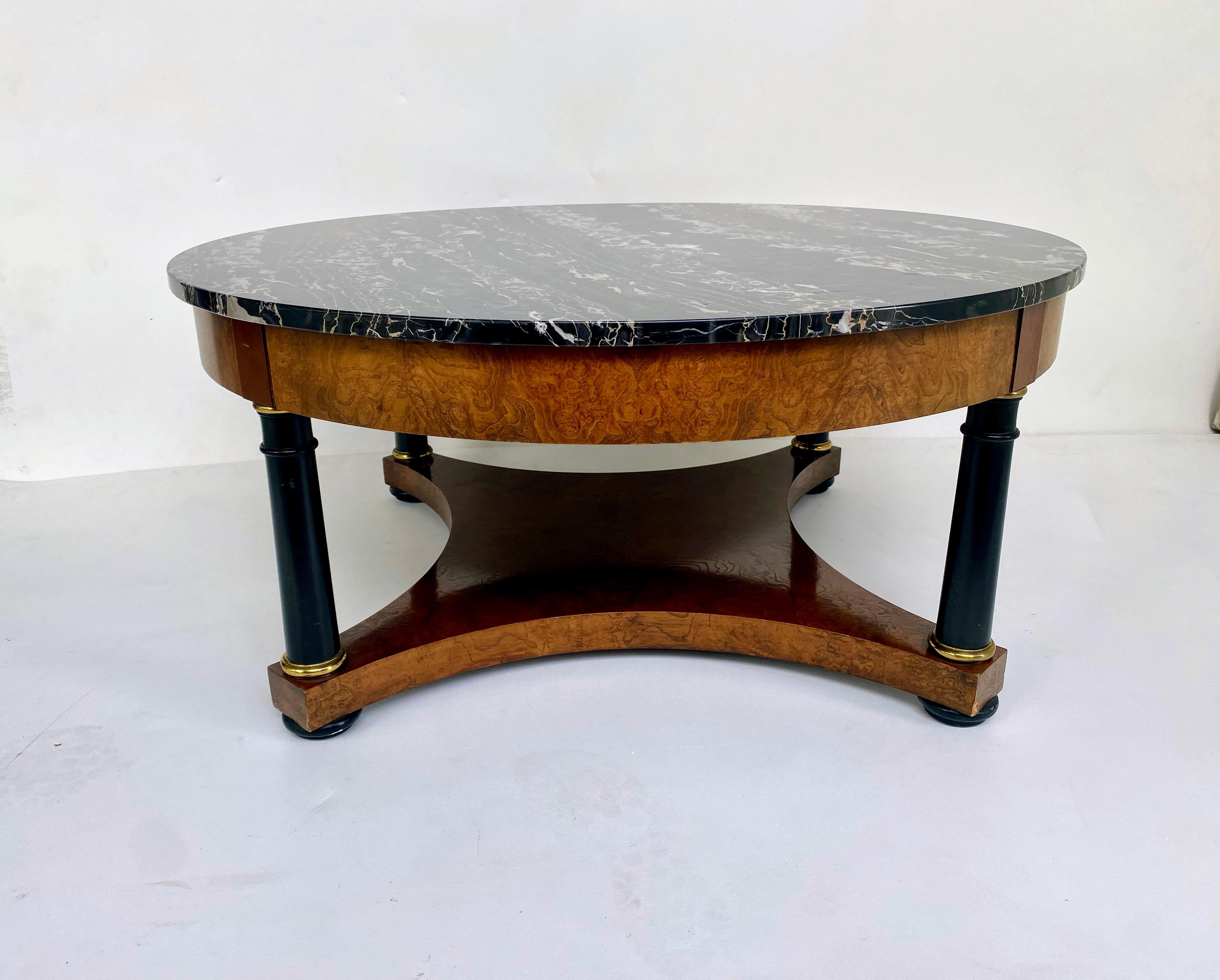 Baker, Knapp & Tubbs Empire Style Cocktail Table with Italian Portoro Marble 

Offered for sale is an elegant Baker, Knapp & Tubbs Empire-style coffee table. The table is created with 4 classical ebonized columns with brass capitals and bases that