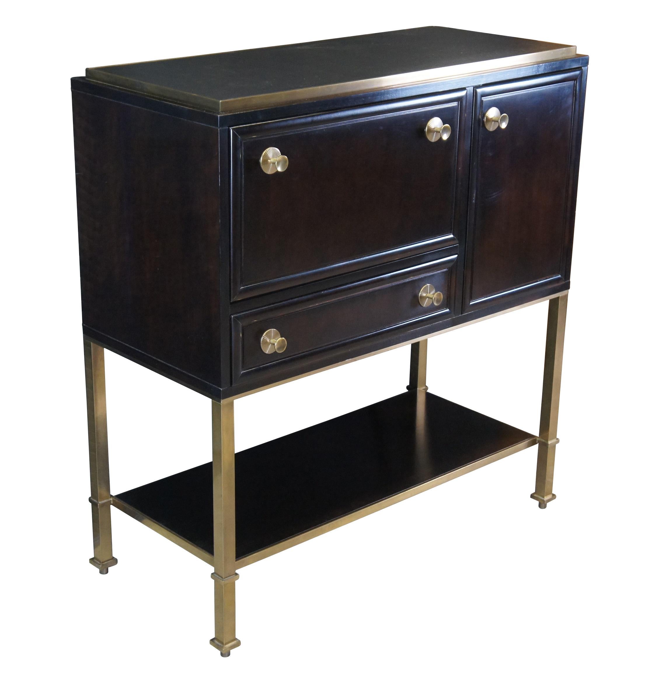 #40272

The Dansu Bar Cabinet by Laura Kirar for Baker Furniture, #9130

Walnut and ebony veneers and brass hardware dress up this bar, which has a black leather-inset top. In addition to the side door and dovetailed oak drawer with liner, there's a