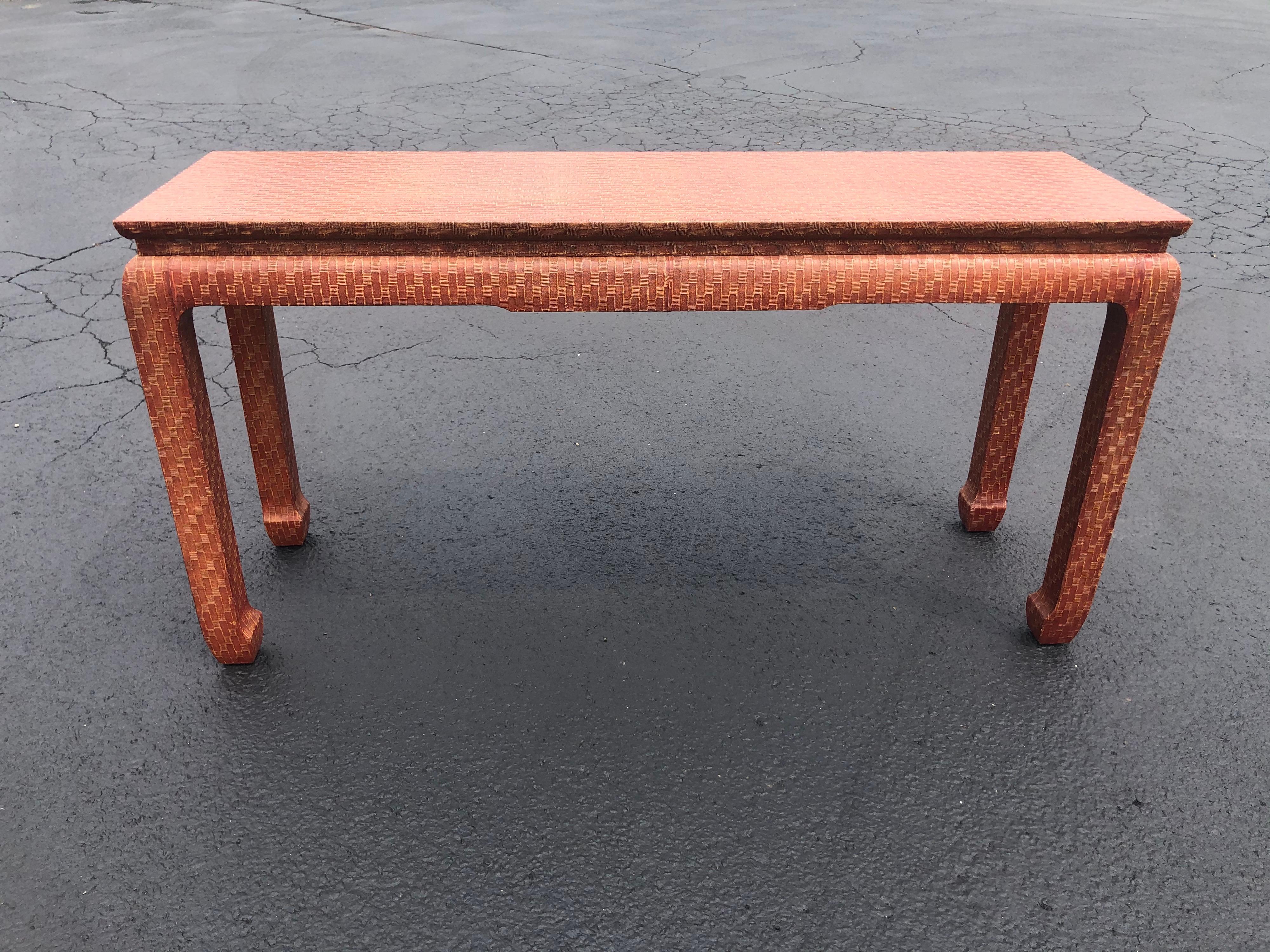 Leather wrapped console Ming table by Baker. Lacquered finish over this gorgeous textured table. This table is  brown with a coral tone to it. It is NOT orange.
Baker brass plate on underside of table. Perfect for an entry way, console or sofa