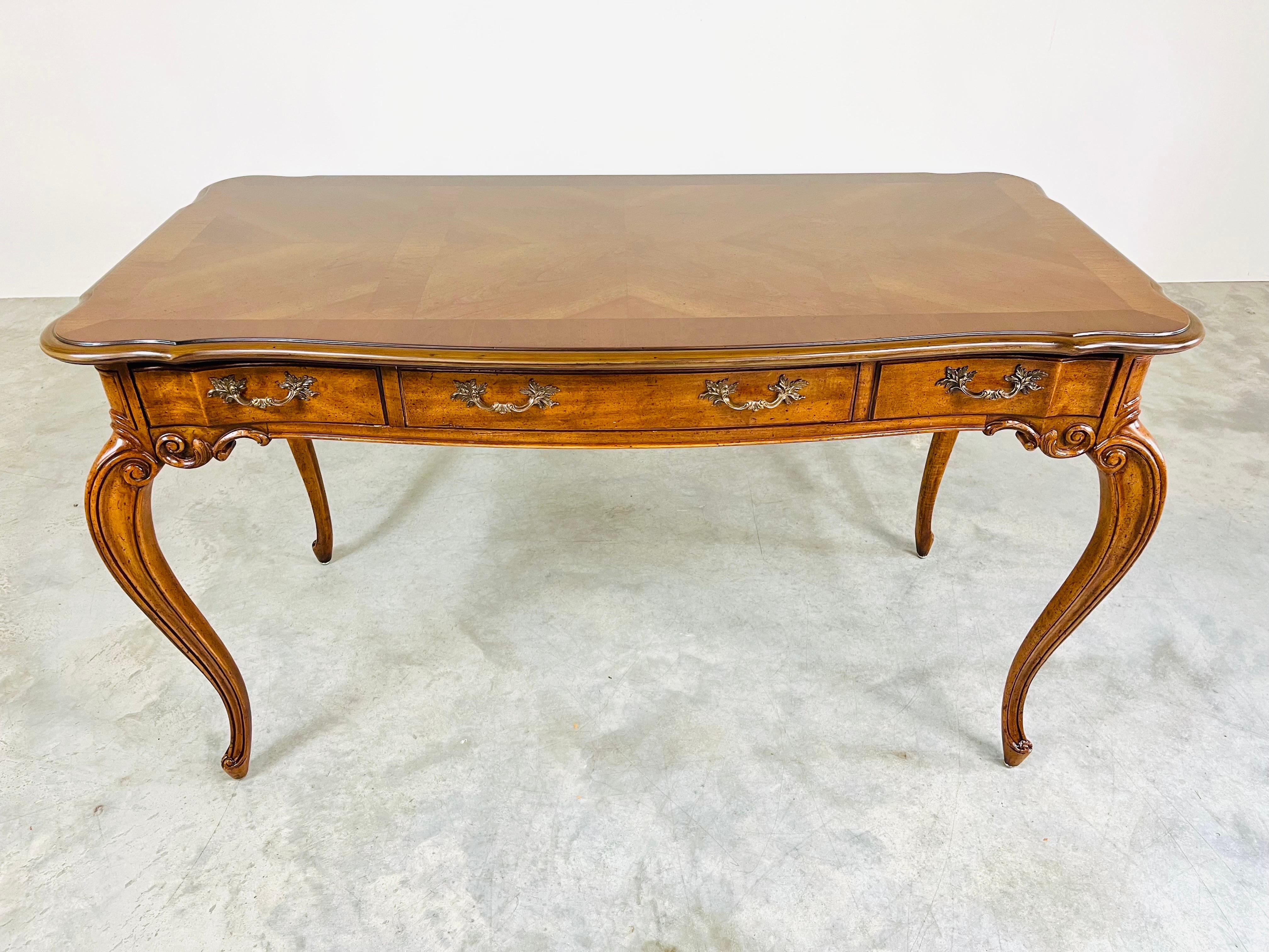 Walnut Louis XV style desk having stunning lines with hand carved accents throughout and detailed brass pulls. An elegant addition to the space that it is placed in. 
Excellent condition. Solid, clean and ready for use! 
30x52x26” HWD Seated leg
