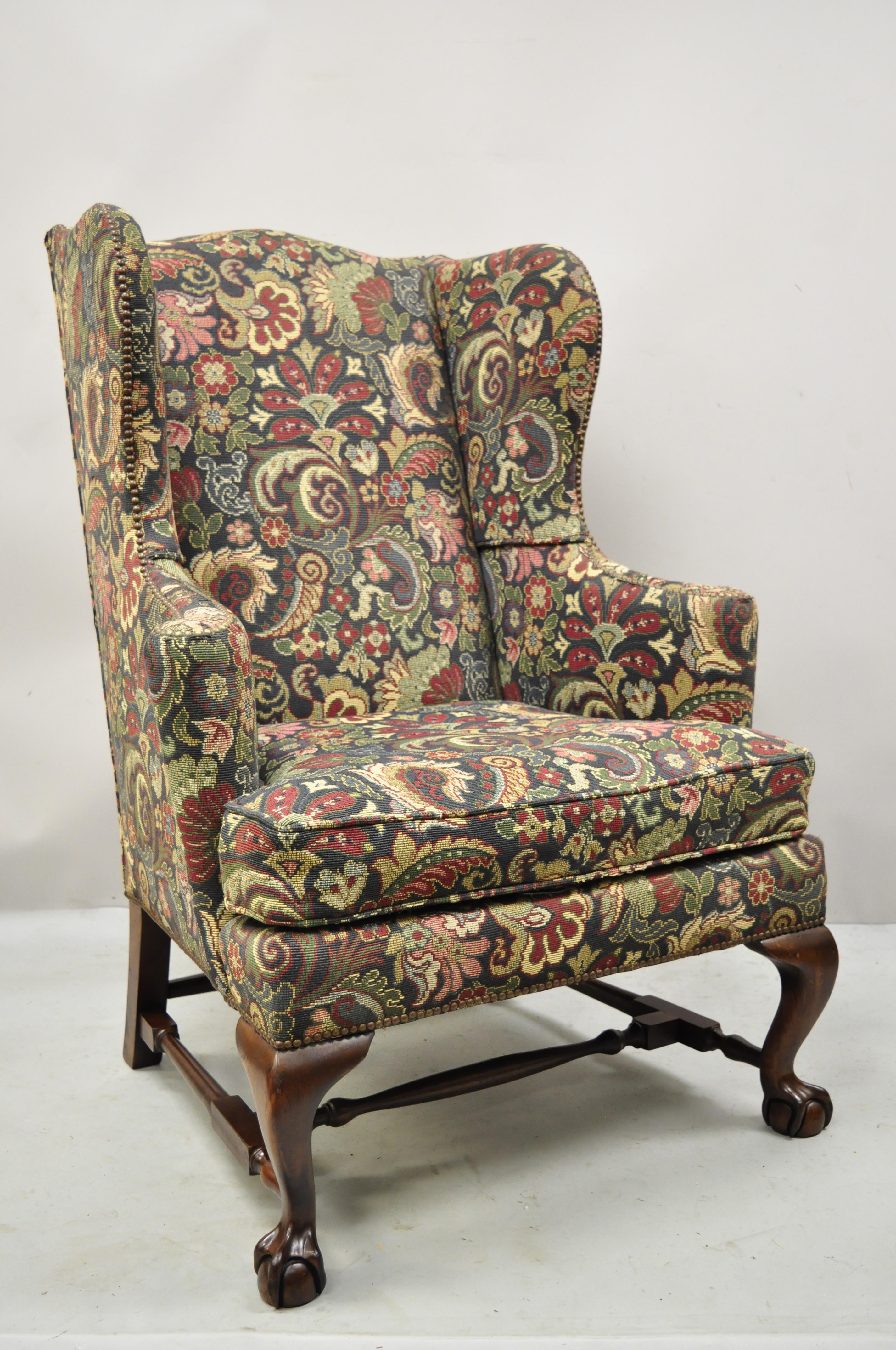 Baker mahogany ball and claw wingback lounge arm chair vintage blue floral upholstery. Item features stretcher base, original floral print upholstery, nailhead trim, solid mahogany wood construction, original label, carved ball and claw feet, very