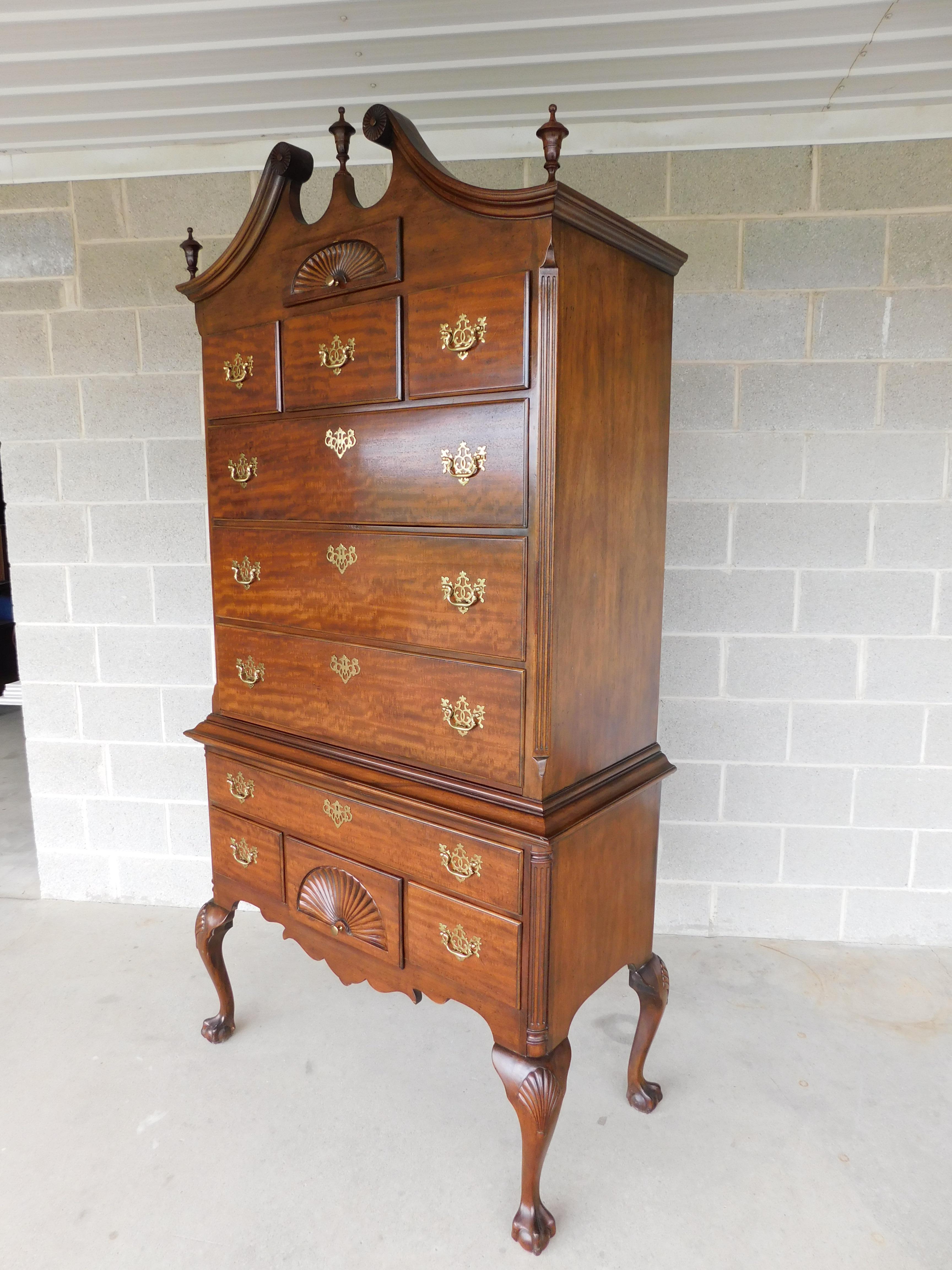 Chippendale style, broken arch top with pediment center, and 2 finials flank the left and right. Top center shell carved face drawer, 1 pc Cabinet with 6 over 4 dovetailed drawers, Drawer fronts appear to be in a quarter sawn mahogany cut pattern