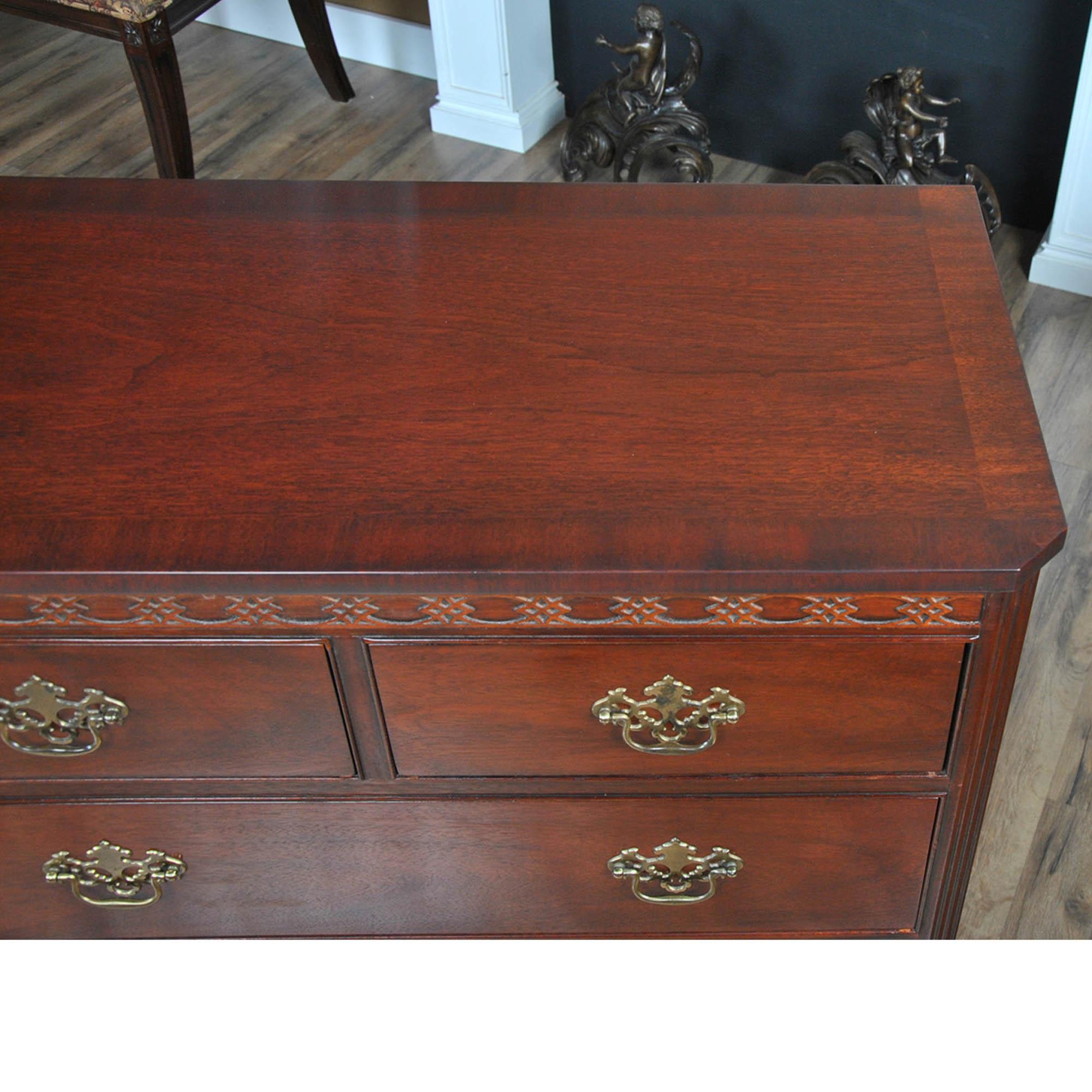 A Mahogany Triple Dresser by Baker Furniture. A classic furniture shape this chest features three drawers  across the top section and two rows of two drawers below to give this large dresser an elegant and traditional furniture appearance that is