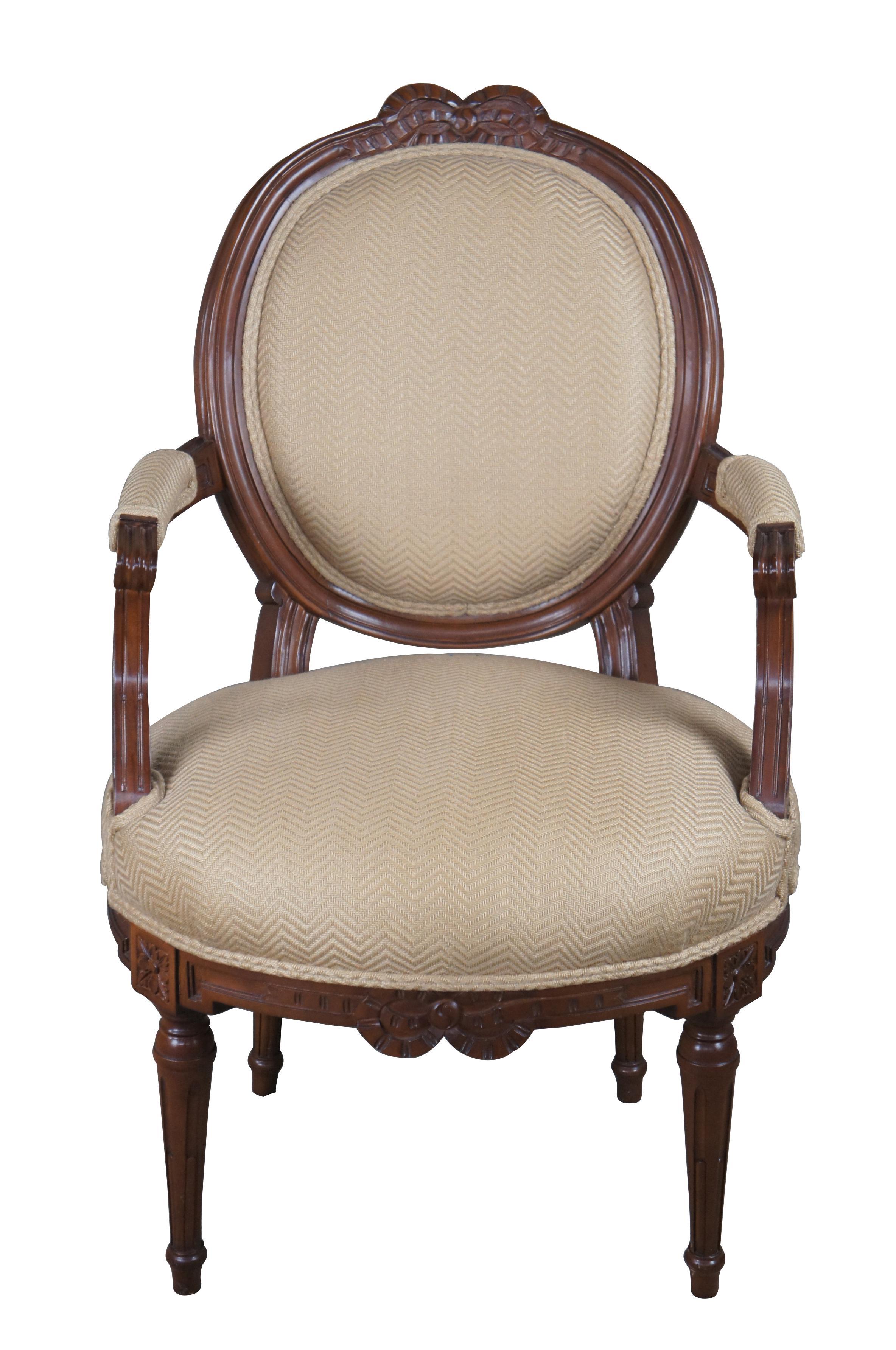 Vintage Baker Furniture Mcmillen collection fauteuil balloon back armchair featuring Louis XVI / Neoclassical styling with carved ribbons, floral medallions, and tapered fluted legs.

Dimensions:
24