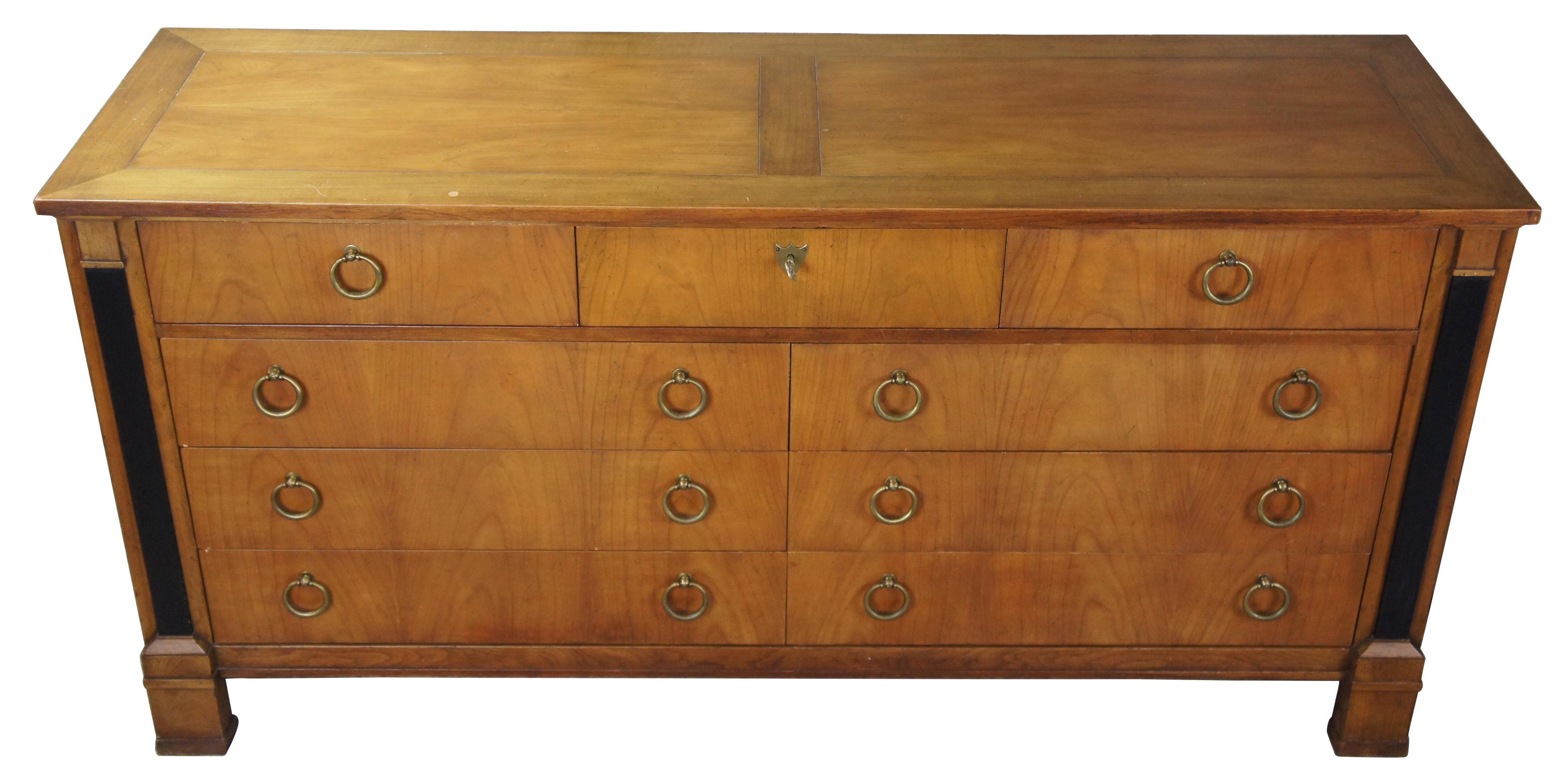 Baker Furniture neoclassical inspired chest of drawers, circa 1960s . Made from Fruitwood with ebonized mounts along the outside, nine drawers and brass hardware. Measures: 64