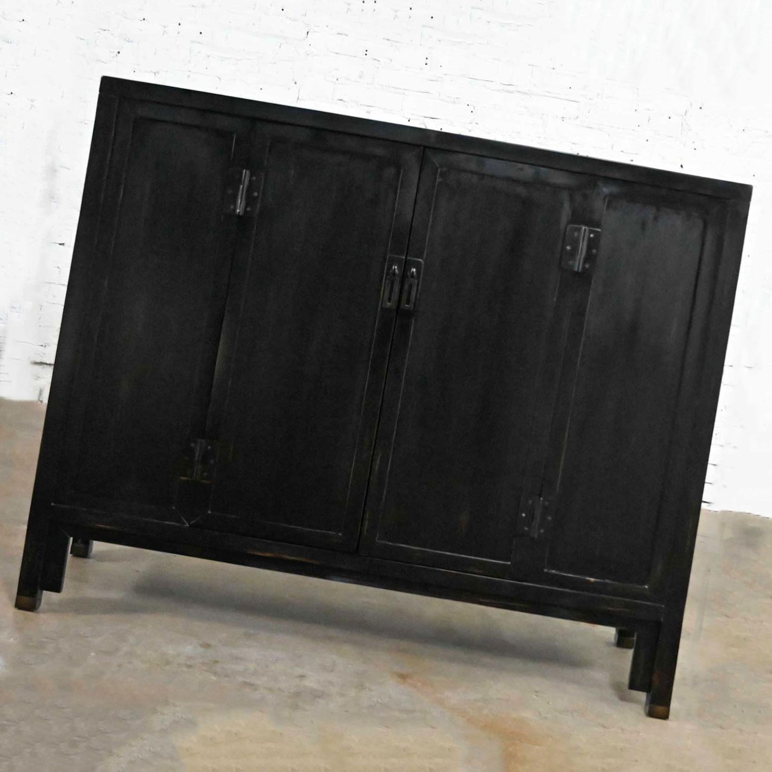 Just look at this Awesome Han style bar cabinet or tall console by Baker Furniture! It’s from their Milling Road Collection and is comprised of gorgeous, ebonized hardwood and is adorned with metal hardware and fittings. It is loaded with storage