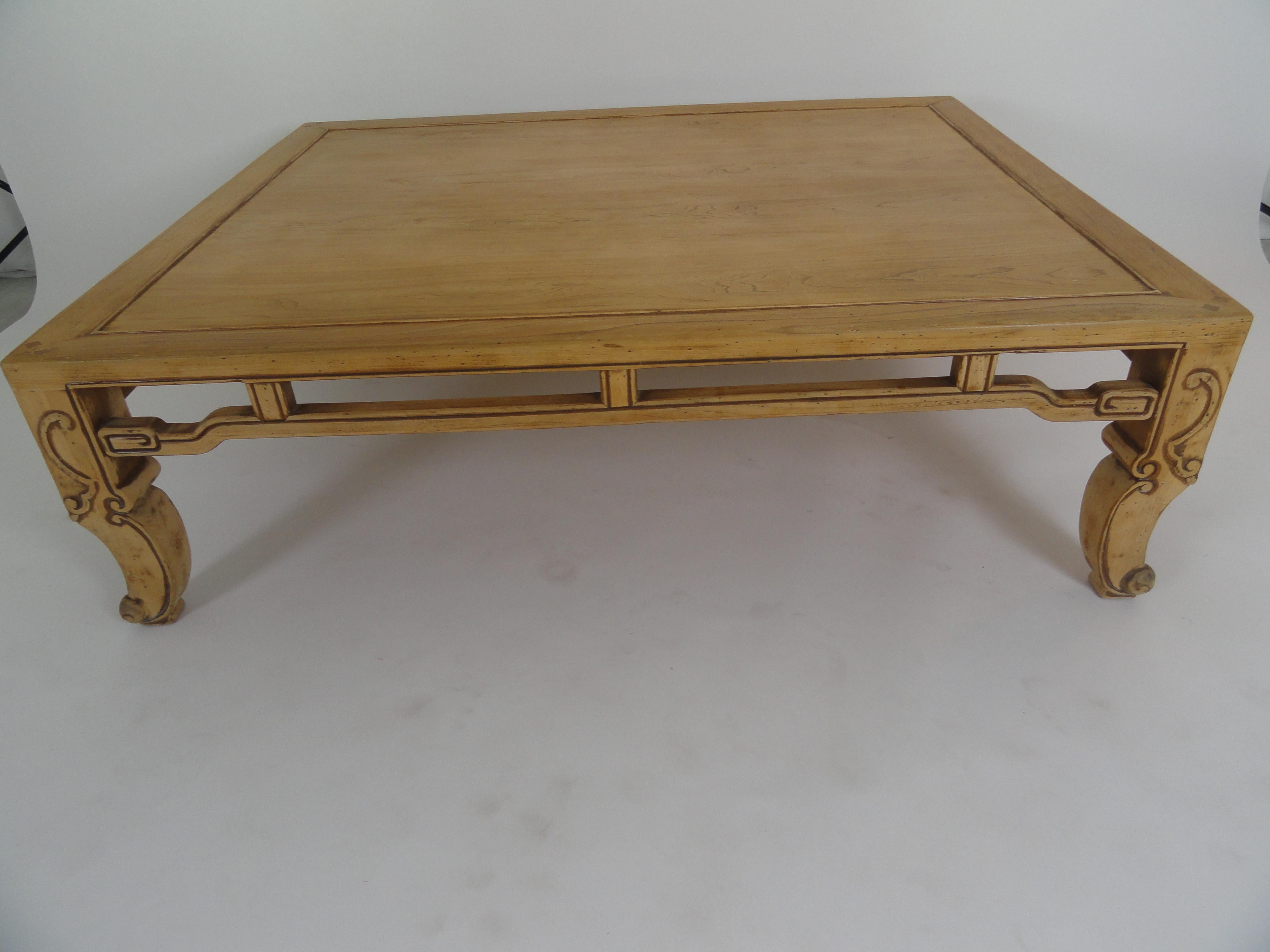 Baker Ming style coffee table in natural wood finish with detailed carving. Baker tag on bottom.