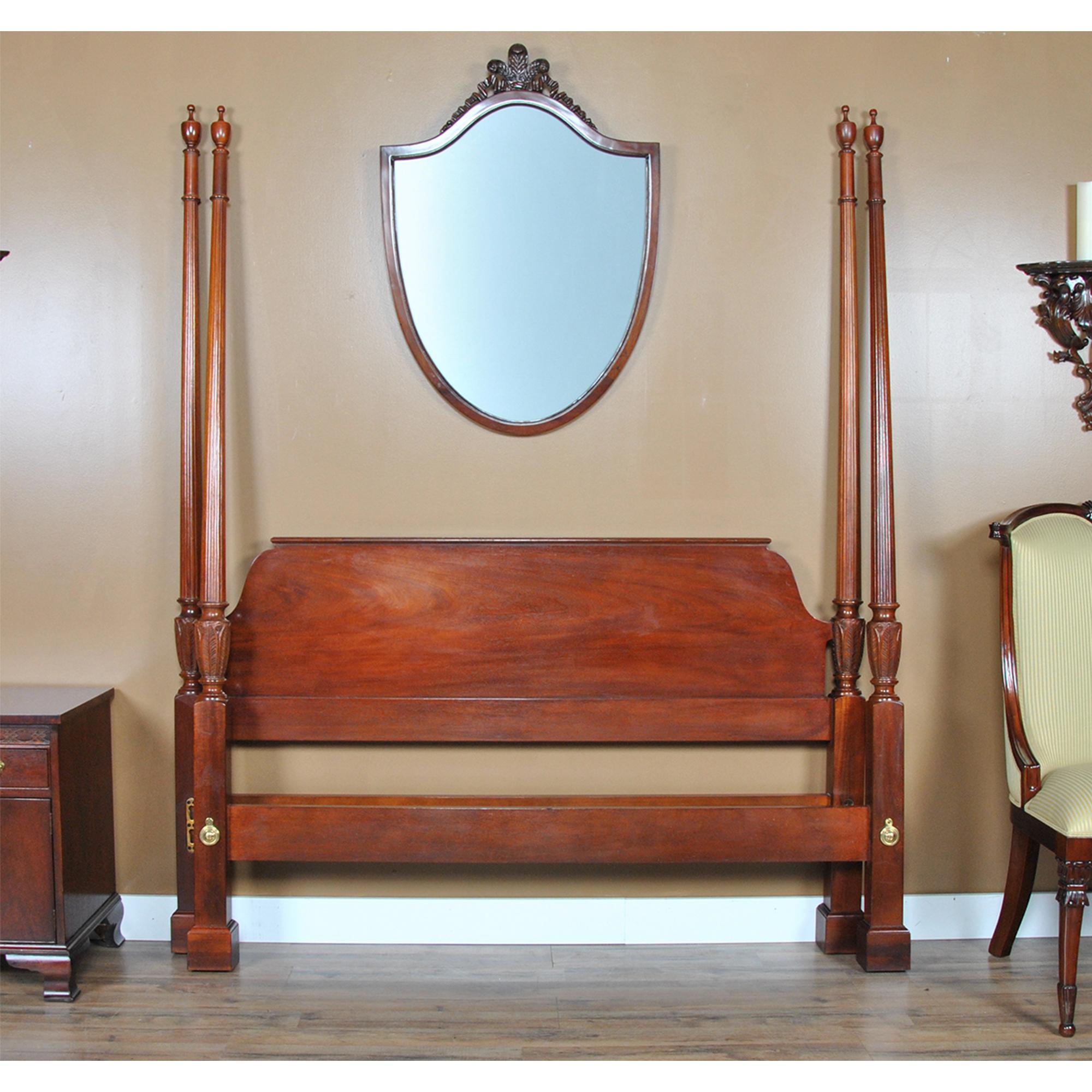 A vintage Baker Mahogany Poster Bed which will be the focal point of any bed room in which it is placed. From the beautifully tapered finials and posts all of the way down to the solid square legs this bed has a great traditional look which gives it