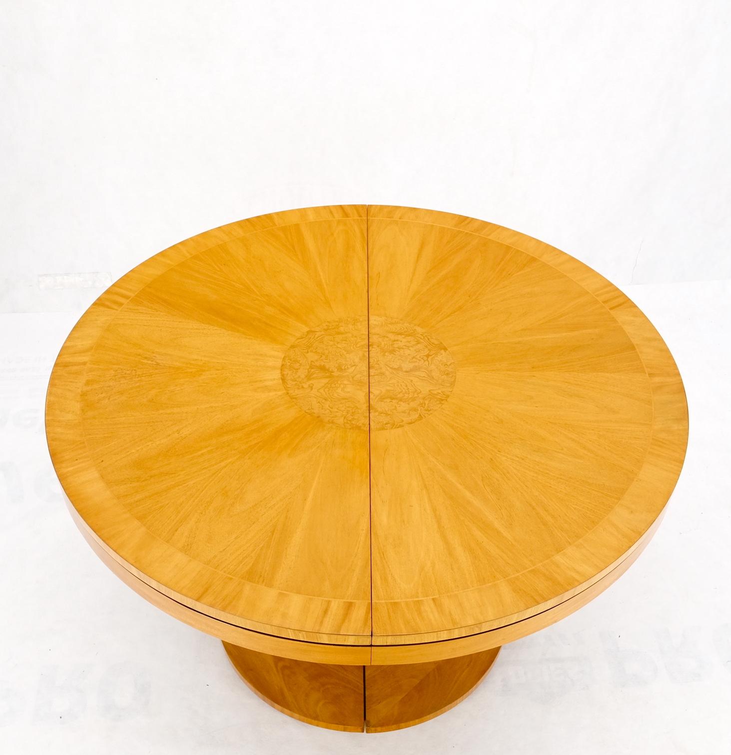 Baker satin wood blond single pedestal banded round dining table two leaves mint!
2 Table leaves measuring 22 inches across.
 