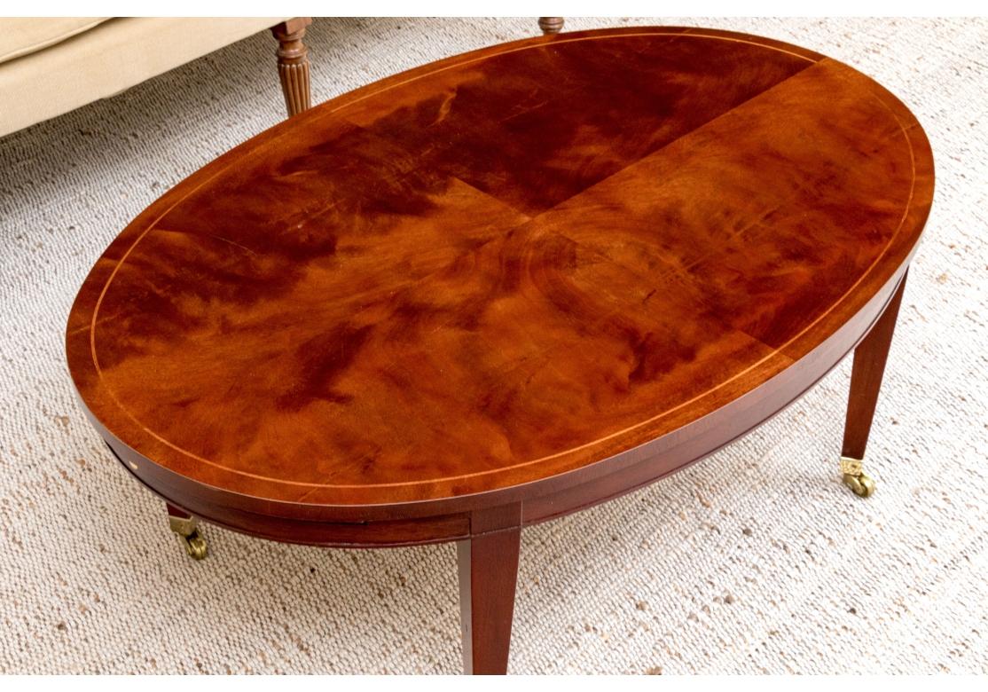 American Baker Sheraton Style Mahogany Oval Cocktail Table With Pull Out Trays For Sale